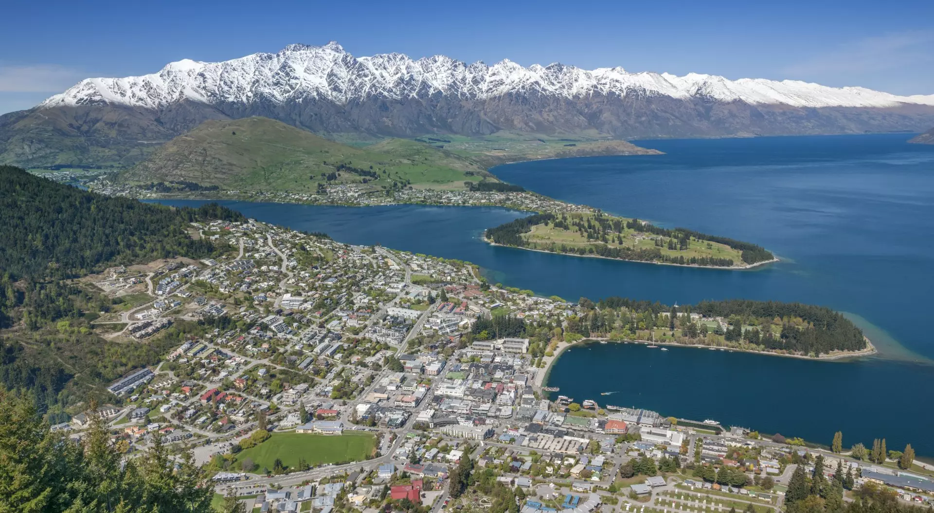 New Zealand Queenstown and The Remarkables Panorama, Otago, New Zealand. Spring has just started and the peaks of the Remarkables in back got their last powder snow.