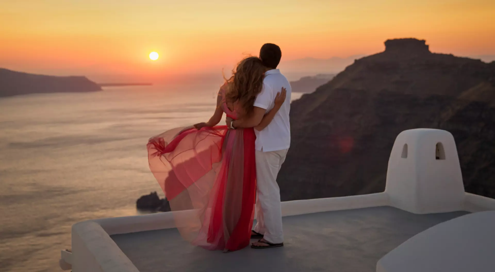 Santorini, Greece Silhouette of a loving couple in Santorini at sunset, Greece Holidays