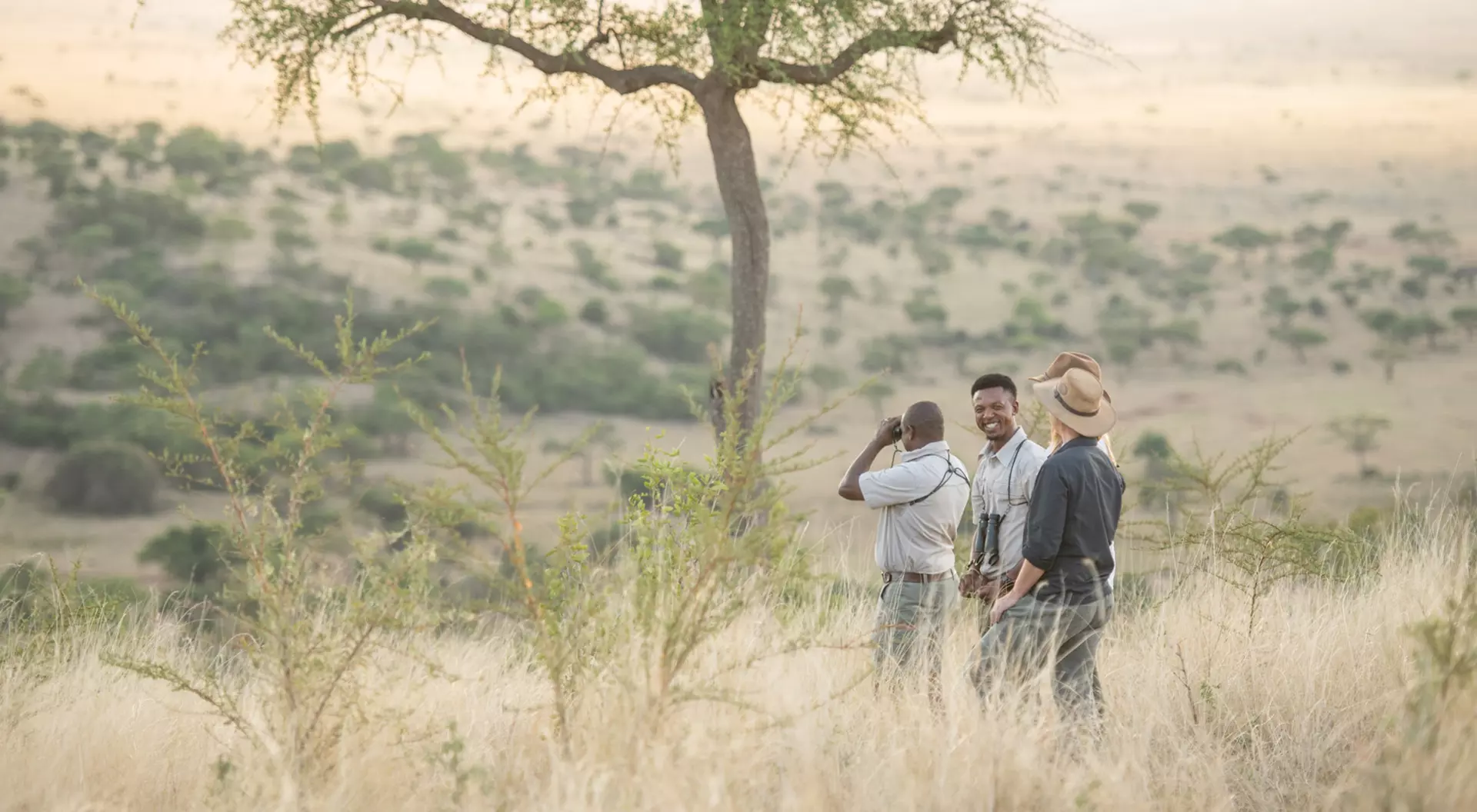 Grumeti Game Reserve, Tanzania Travellers with their guide on the savannah of Grumeti Game Reserve at Singita in Tanzania