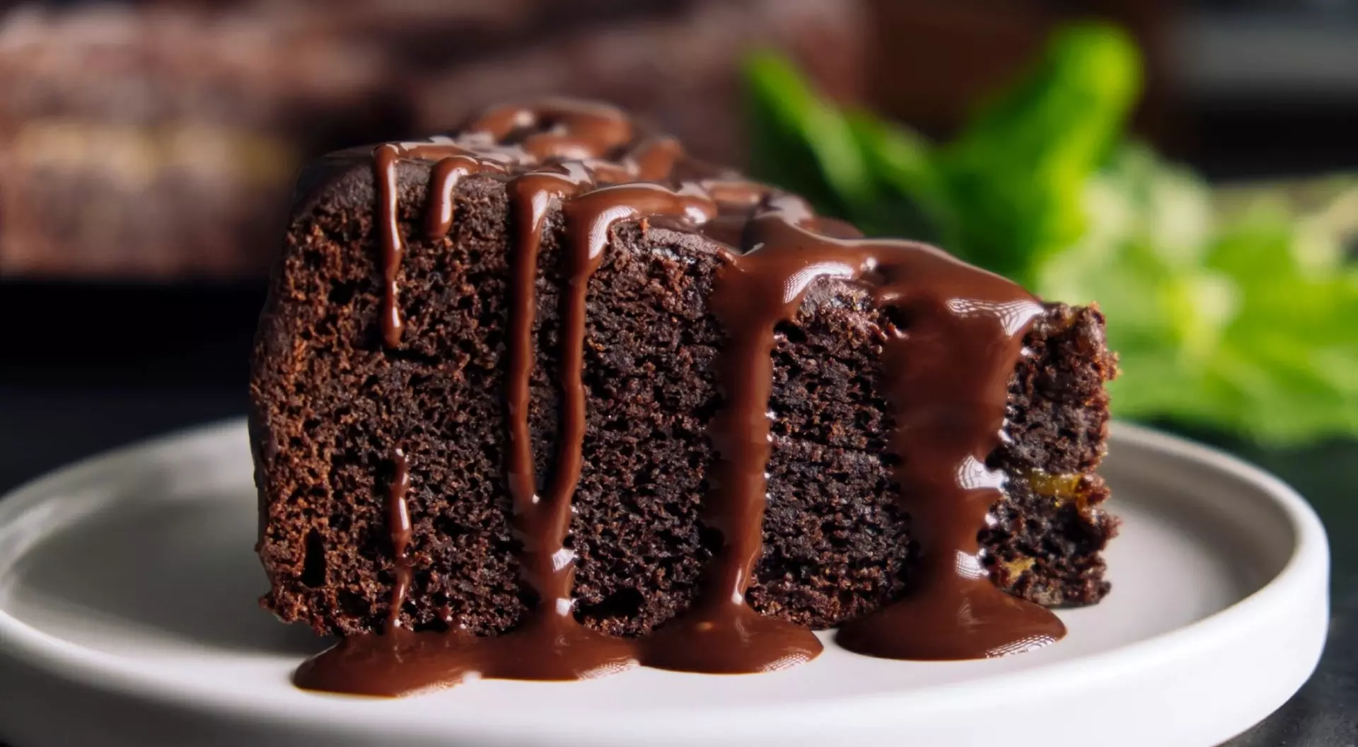 Slice of chocolate cake with glaze on a plate