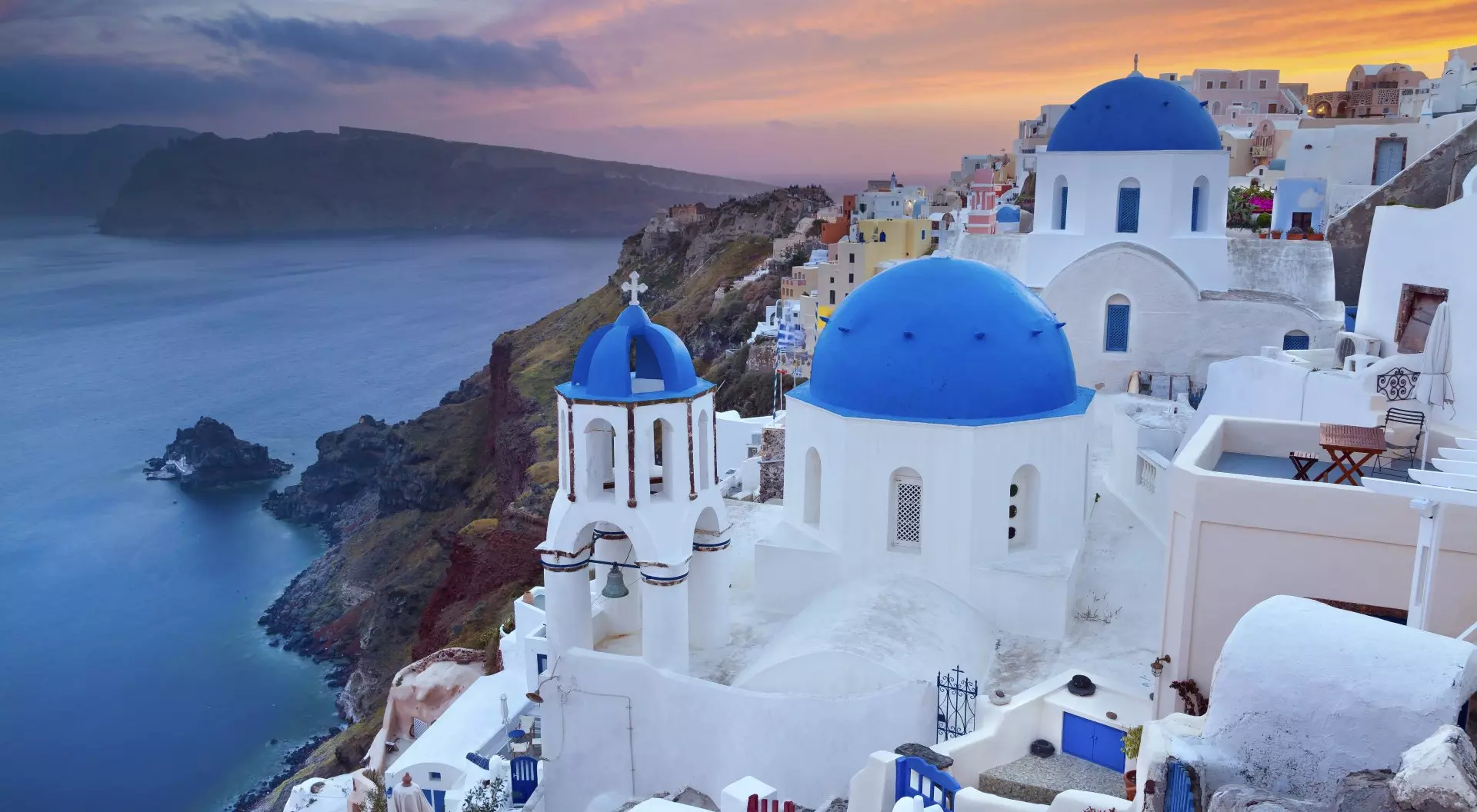 Small Village of Oia at sunset, located on Greek island of Santorini, Greece