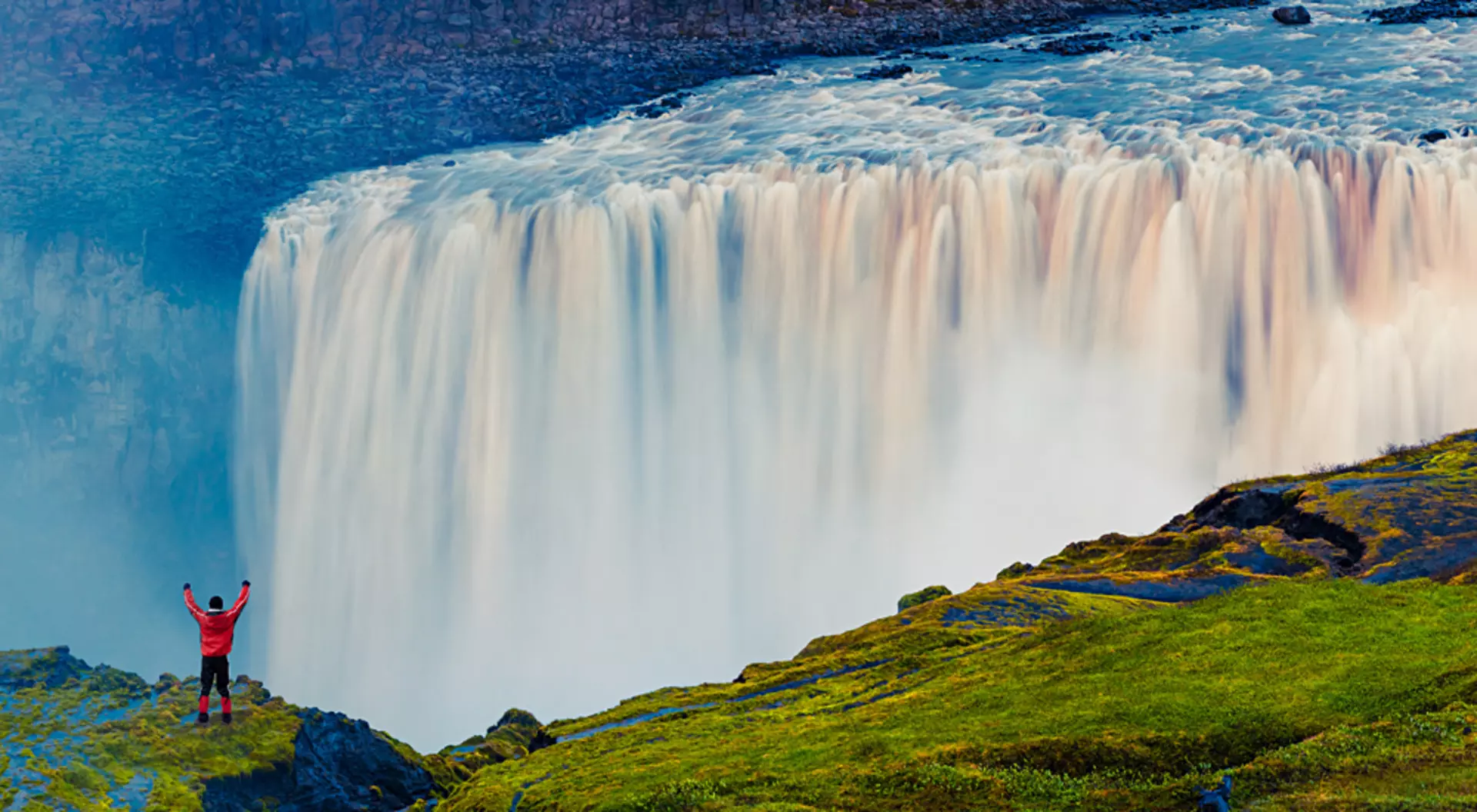 Standing in front of the powerful Dettifoss Falls, Jokulsargljufur National Park, Iceland