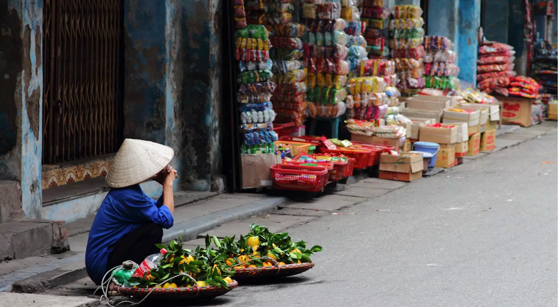 Hanoi, Vietnam Street vendor in Vietnam selling fruit at a corner in Hanoi, Vietnam