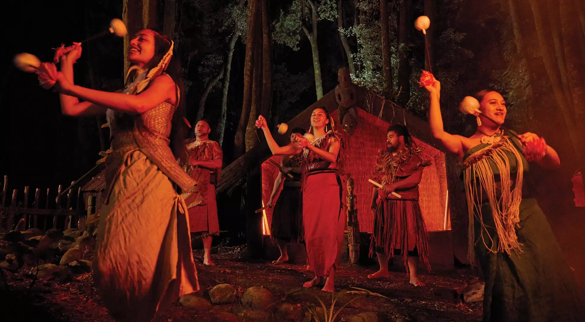 a group of Maori dancers show their moves with traditional outfits