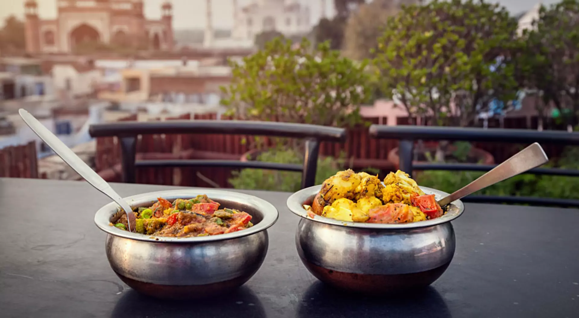 Traditional Indian food in Metal Dish on Rooftop Restaurant with Taj Mahal Background, Agra, Uttar Pradesh, India
