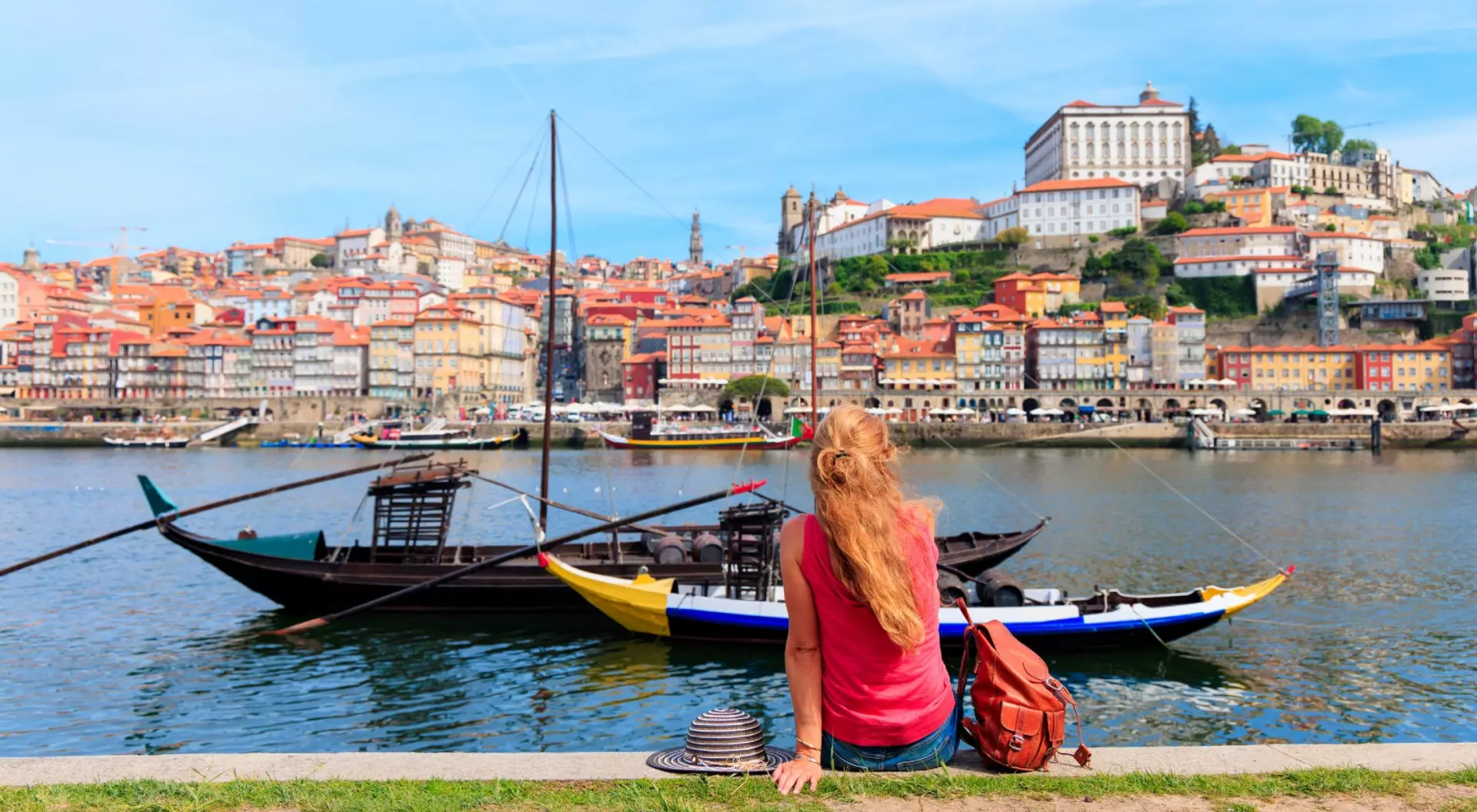 Porto, Portugal Traveler woman tourist enjoying traditional boat on douro river and Porto city- Portugal