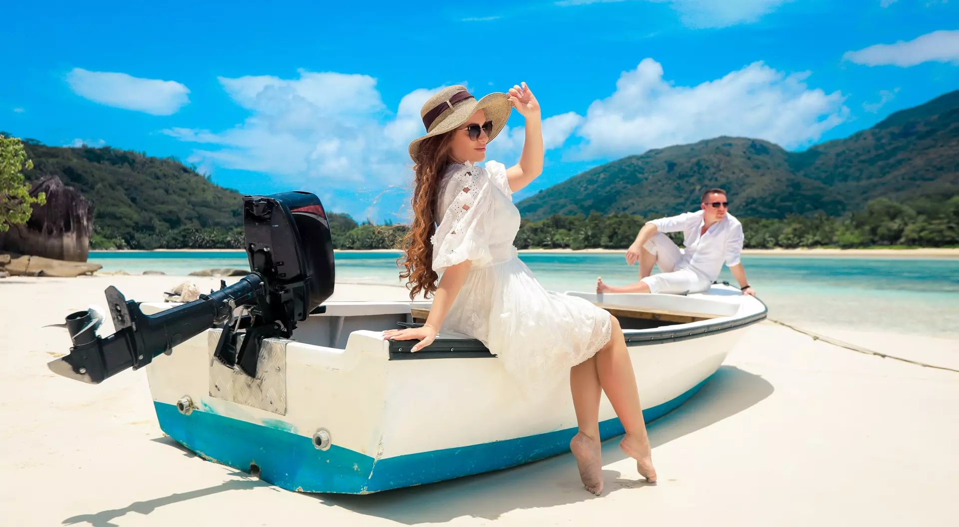 Two lovers and a boat on the paradise Seychelles, tropical island near Mahe