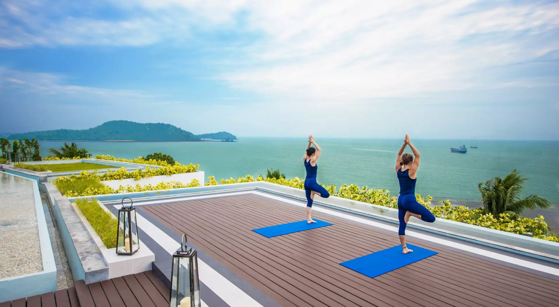 Amatara Wellness Resort, Thailand Two people doing yoga on a vacation at the Amatara Wellness Resort, Thailand.