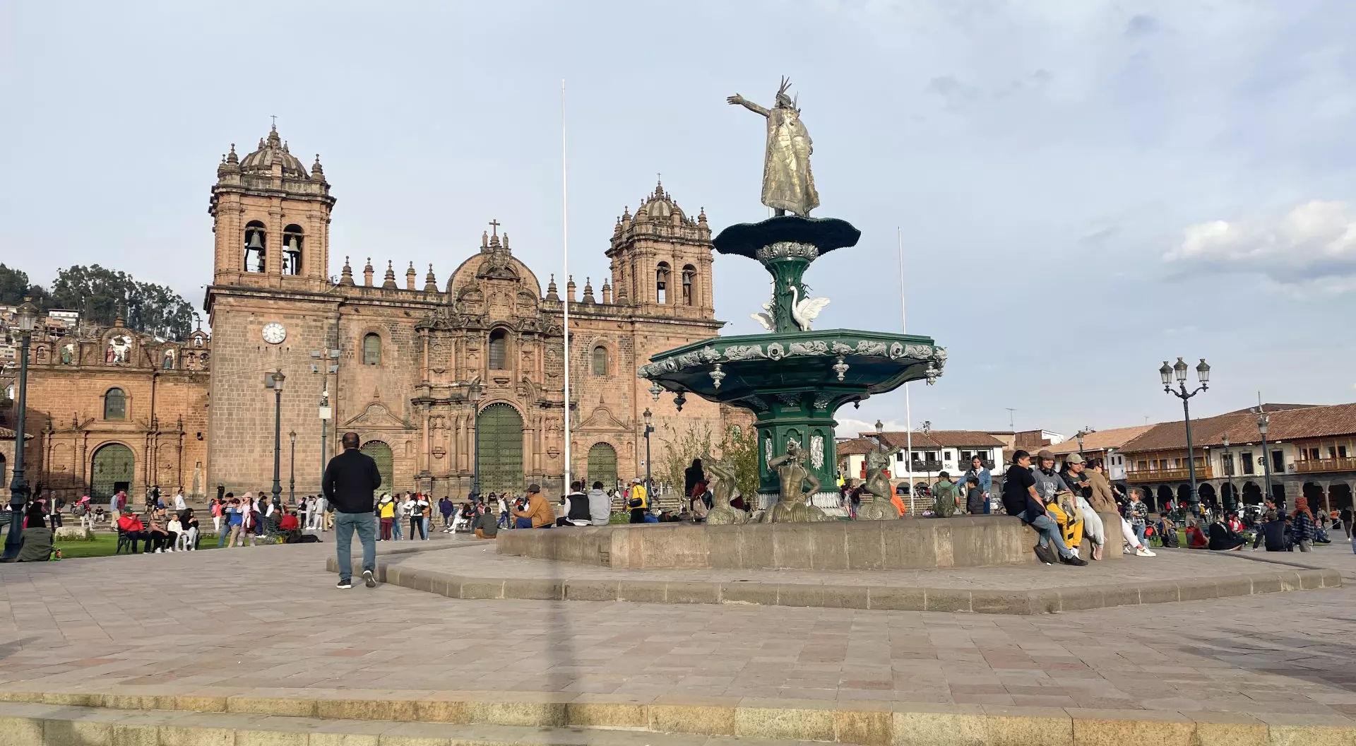 Cusco, Peru View of the Cathedral of Cusco in the Plaza de Armas and and statue of pachacuti, with people visiting- Cusco, Peru