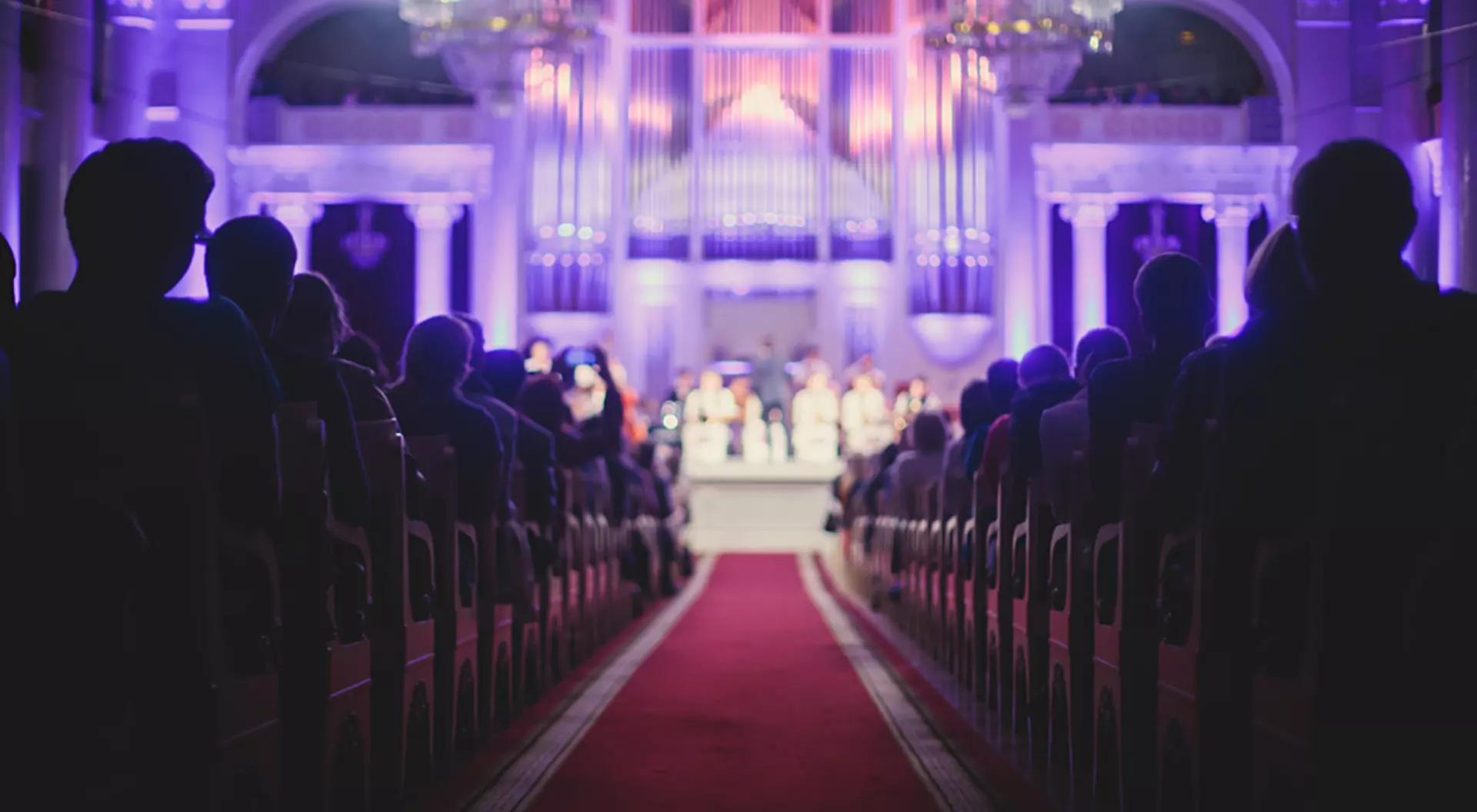 View of philharmonia philharmonic concert hall isle with pipe organ and orchestra playing classical music
