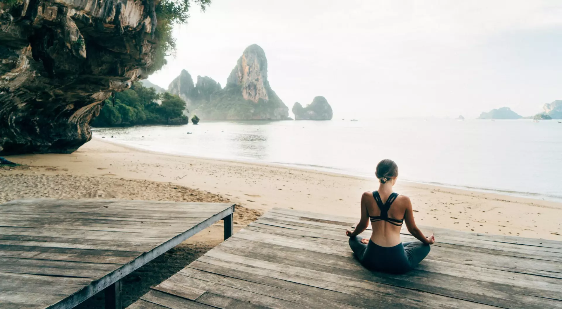 Thailand Woman doing yoga on the beach