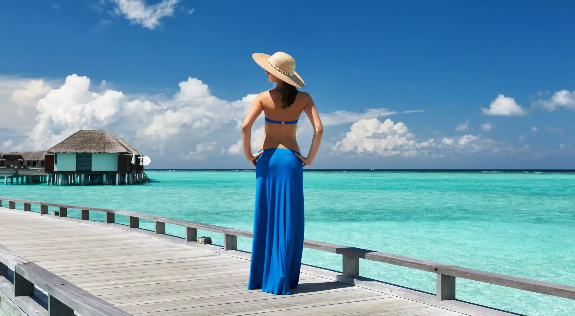 Maldives Woman on a Tropical Beach Jetty in the Maldives