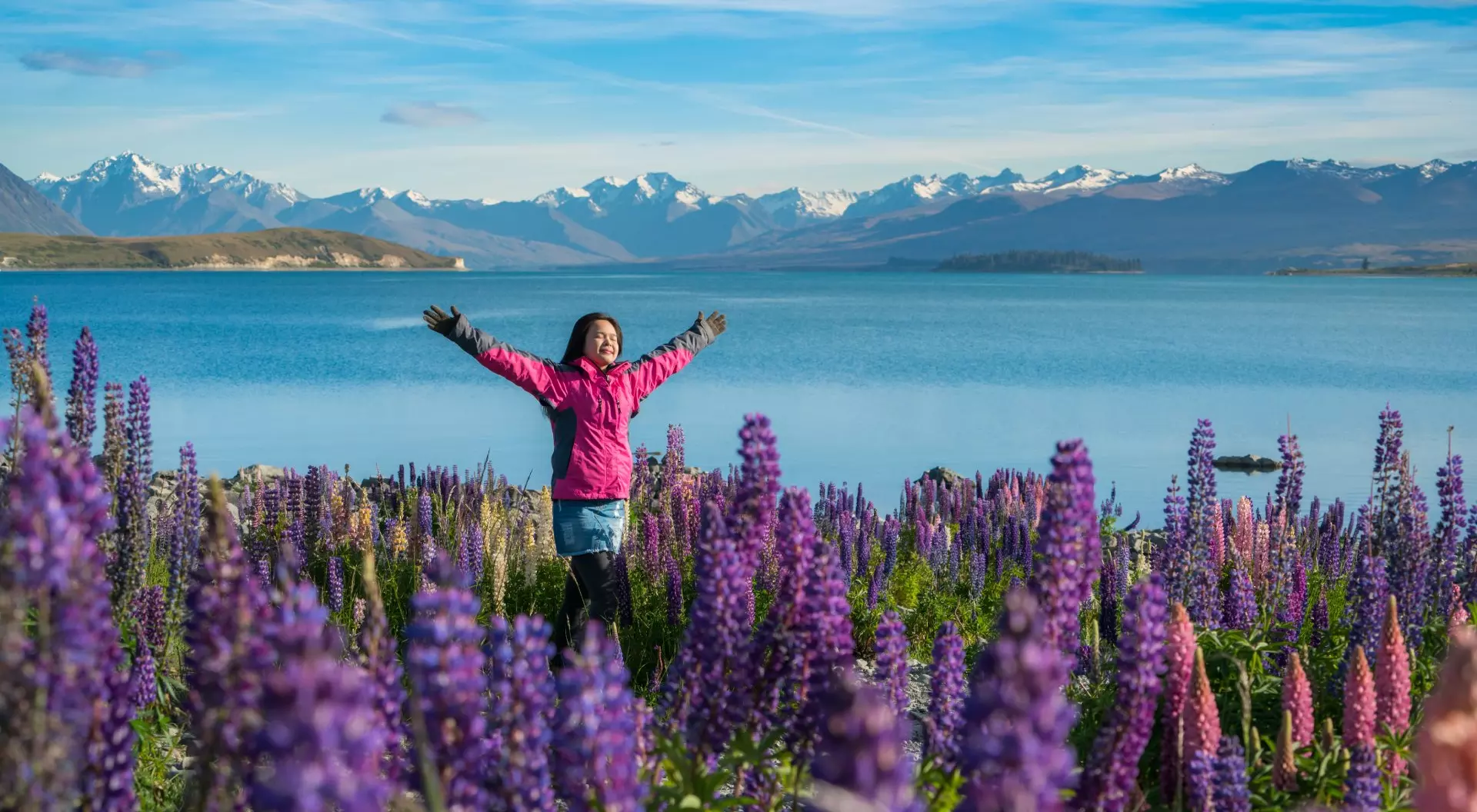 Woman traveller at lake Tekapo in the summer, New Zealand