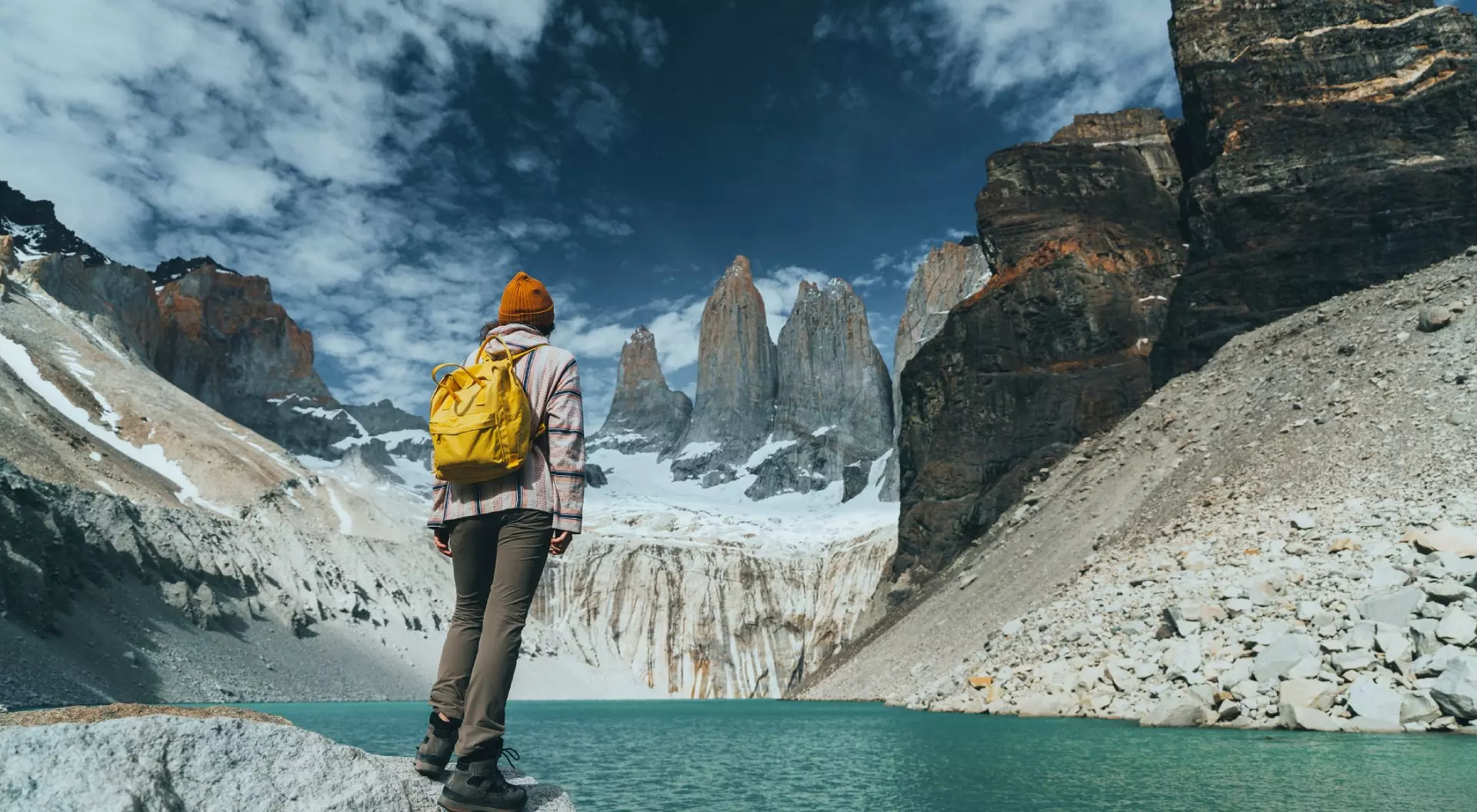 Torres del Paine, Chile Woman with yellow backpack looking at scenic view of Torres del Paine National Park