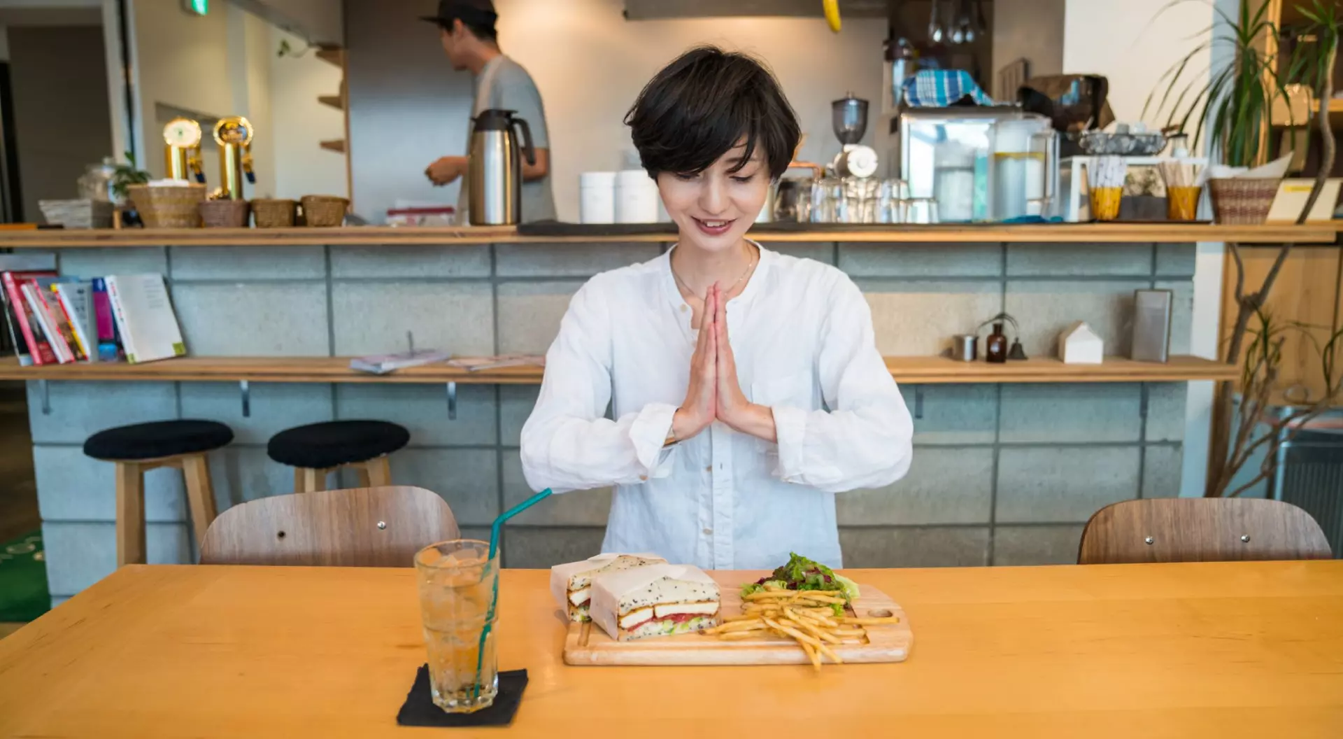Woman about to enjoy lunch in a cafe