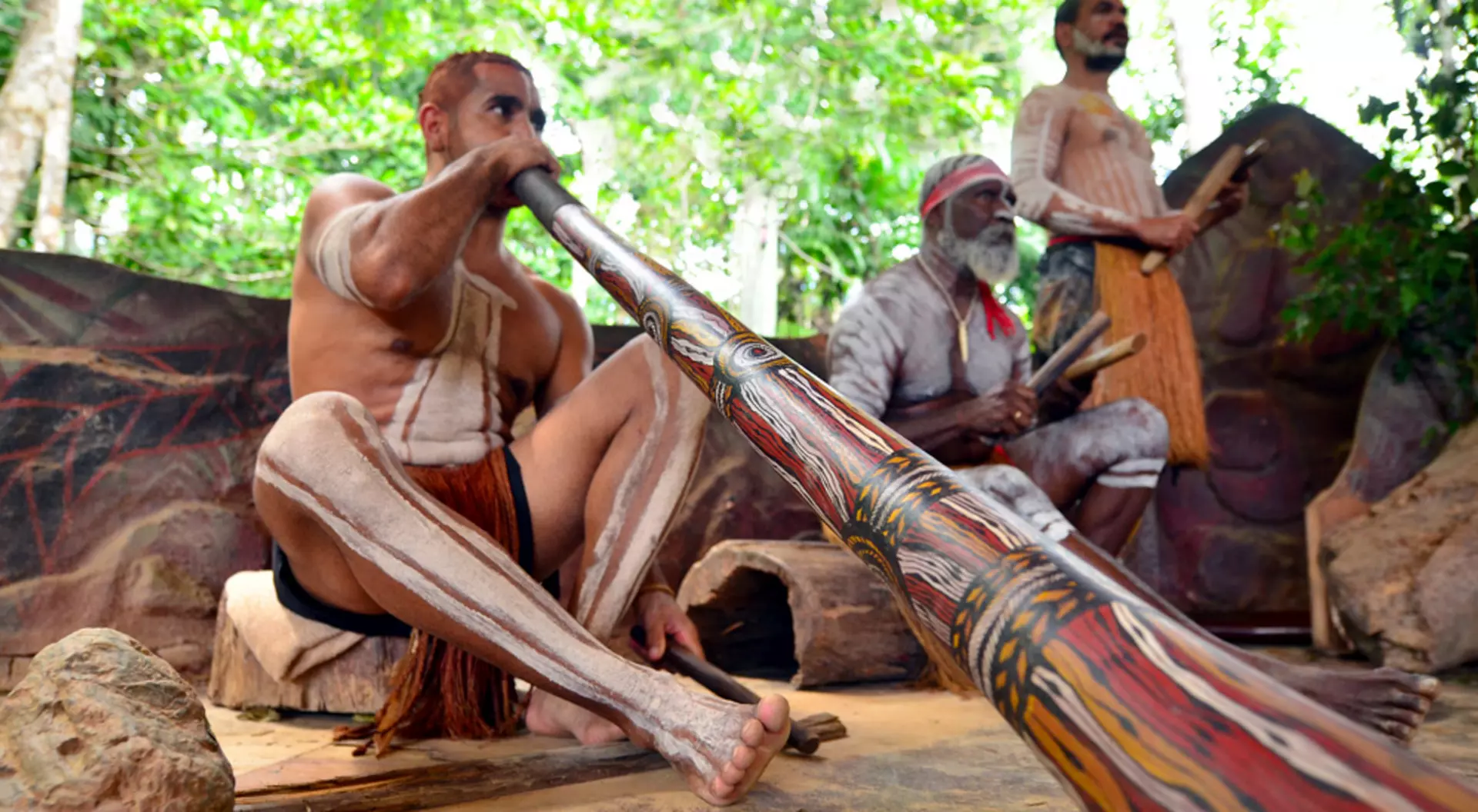 Yirrganydji Aboriginal men play didgeridoo and wooden instrument at culture show, Queensland, Australia