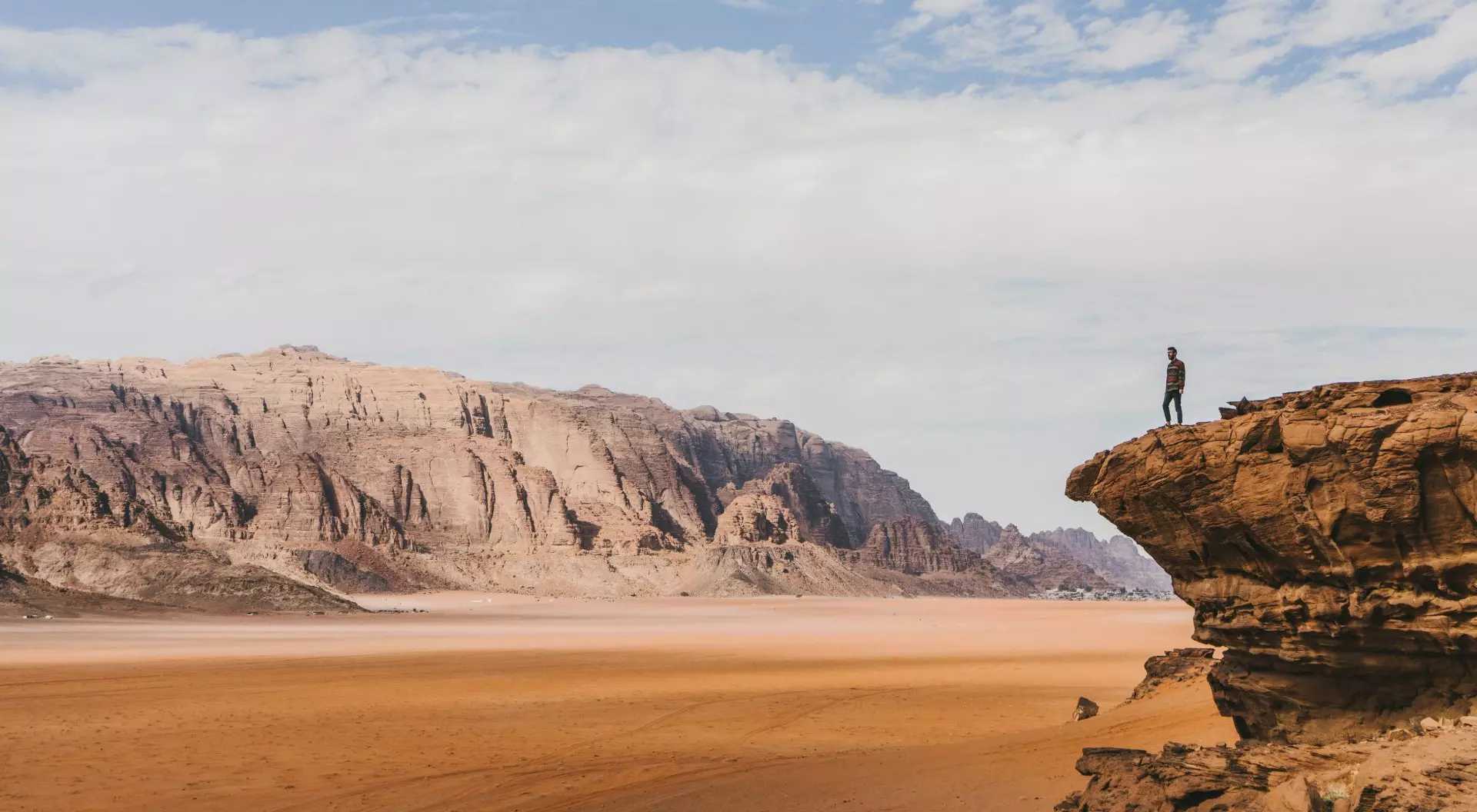Wadi Rum, Jordan Young Caucasian woman looking at Wadi Rum desert from above at sunset