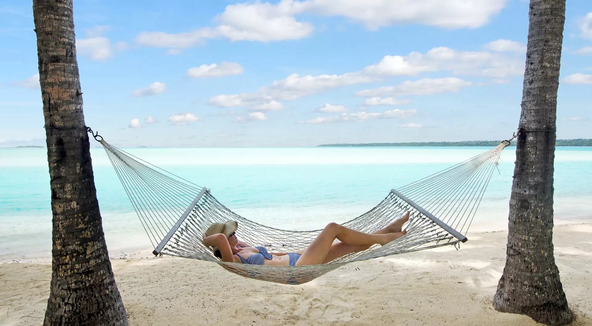 Cook Islands Young Woman Relaxing in Hammock in Aitutaki, Cook Islands