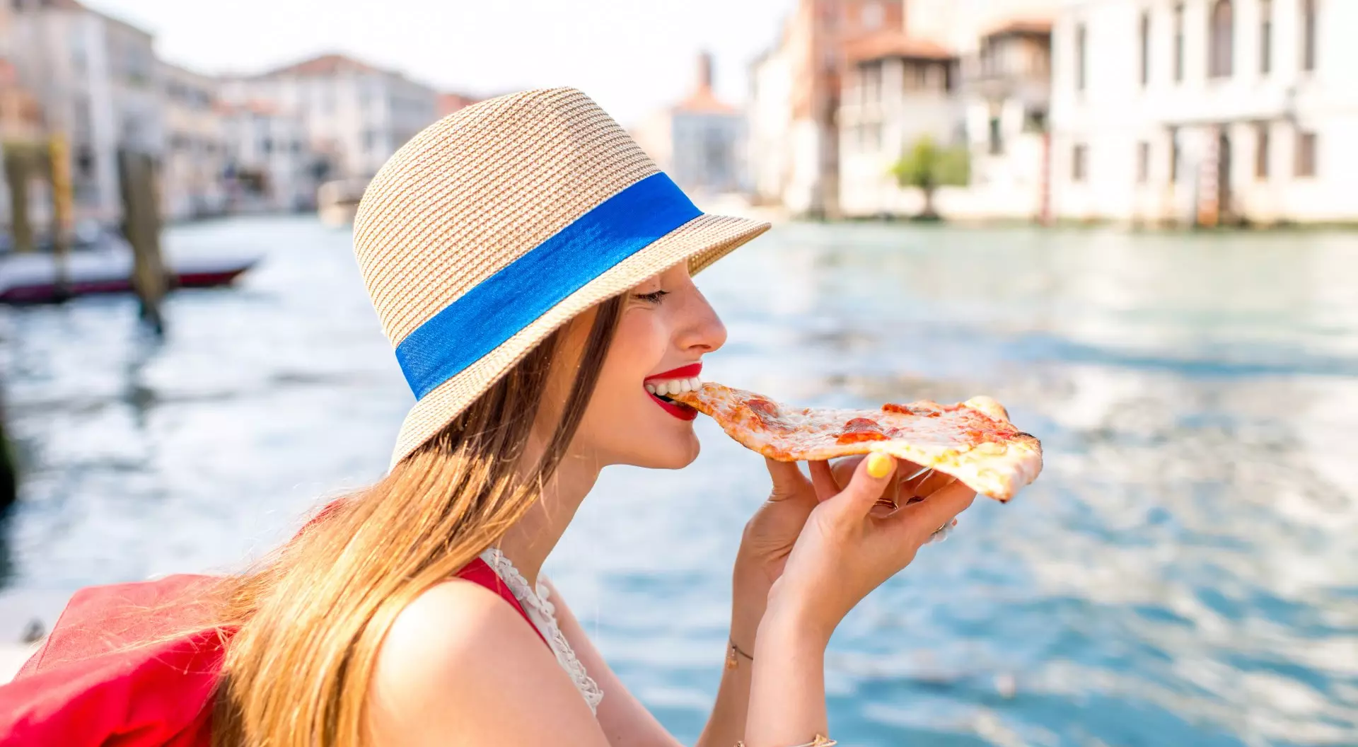 Venice, Italy Young Woman eating traditional italian pizza slice, Venice, Italy