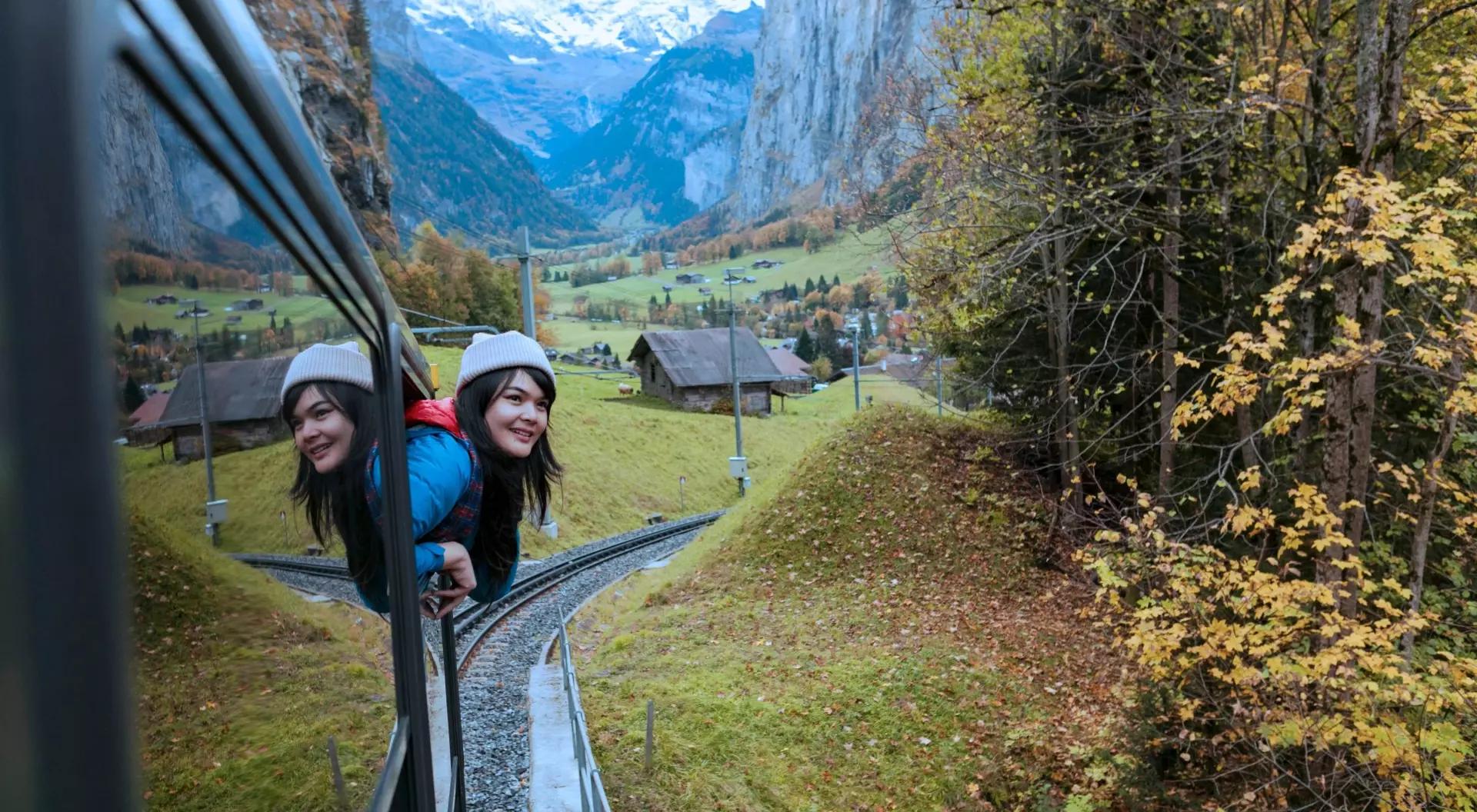 Switzerland a girl sticks her head outside the window as the train passes through the Swiss Alps