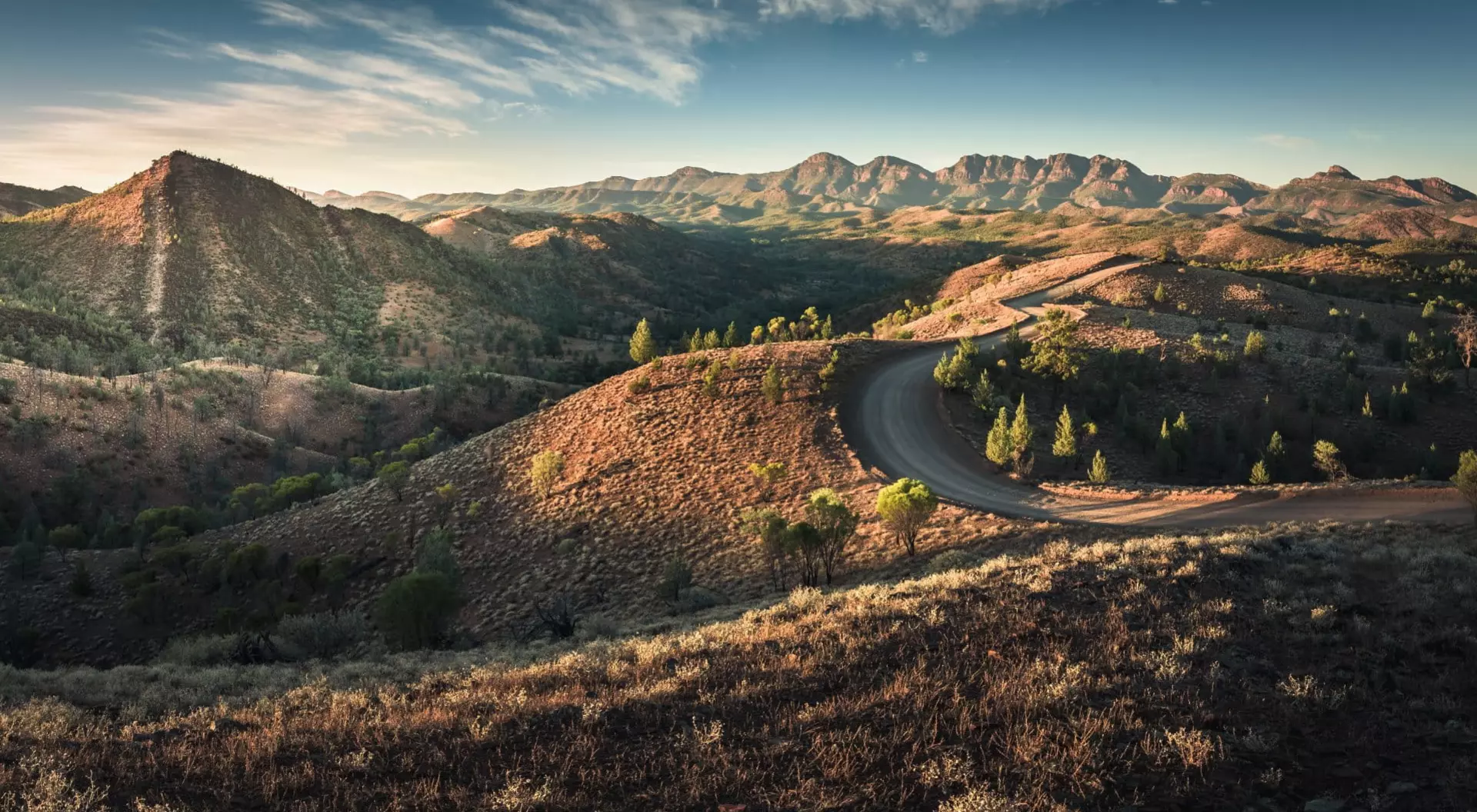 view of golden hills and a road