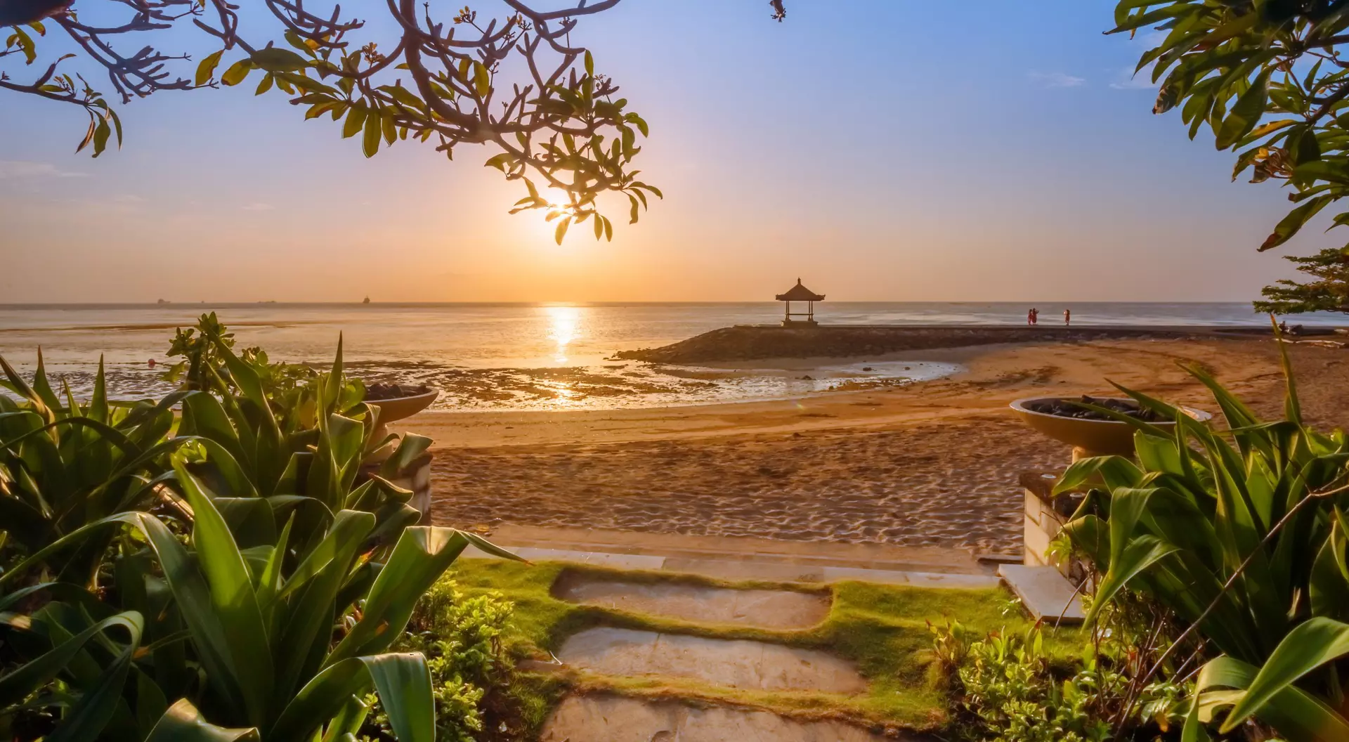 Bali, Indonesia beach at sunset with plants surrounding