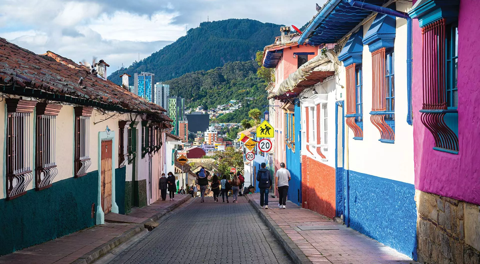 colourful homes on street with background mountain