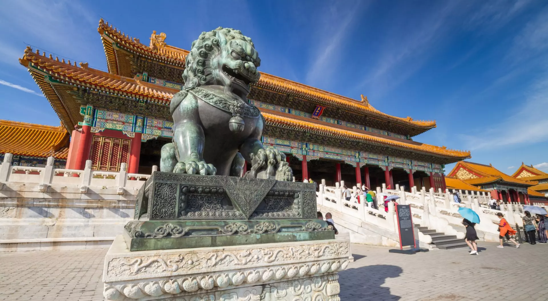 Forbidden City, Beijing, China statue of a lion outside a massive chinese palace
