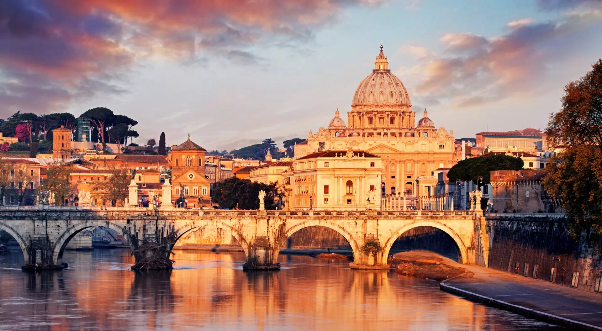 Church dome overlooking bridge and river at sunset