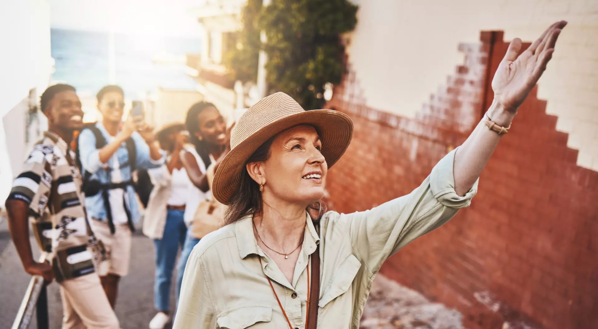 a tour guide leads a group of travels through an old city in Europe