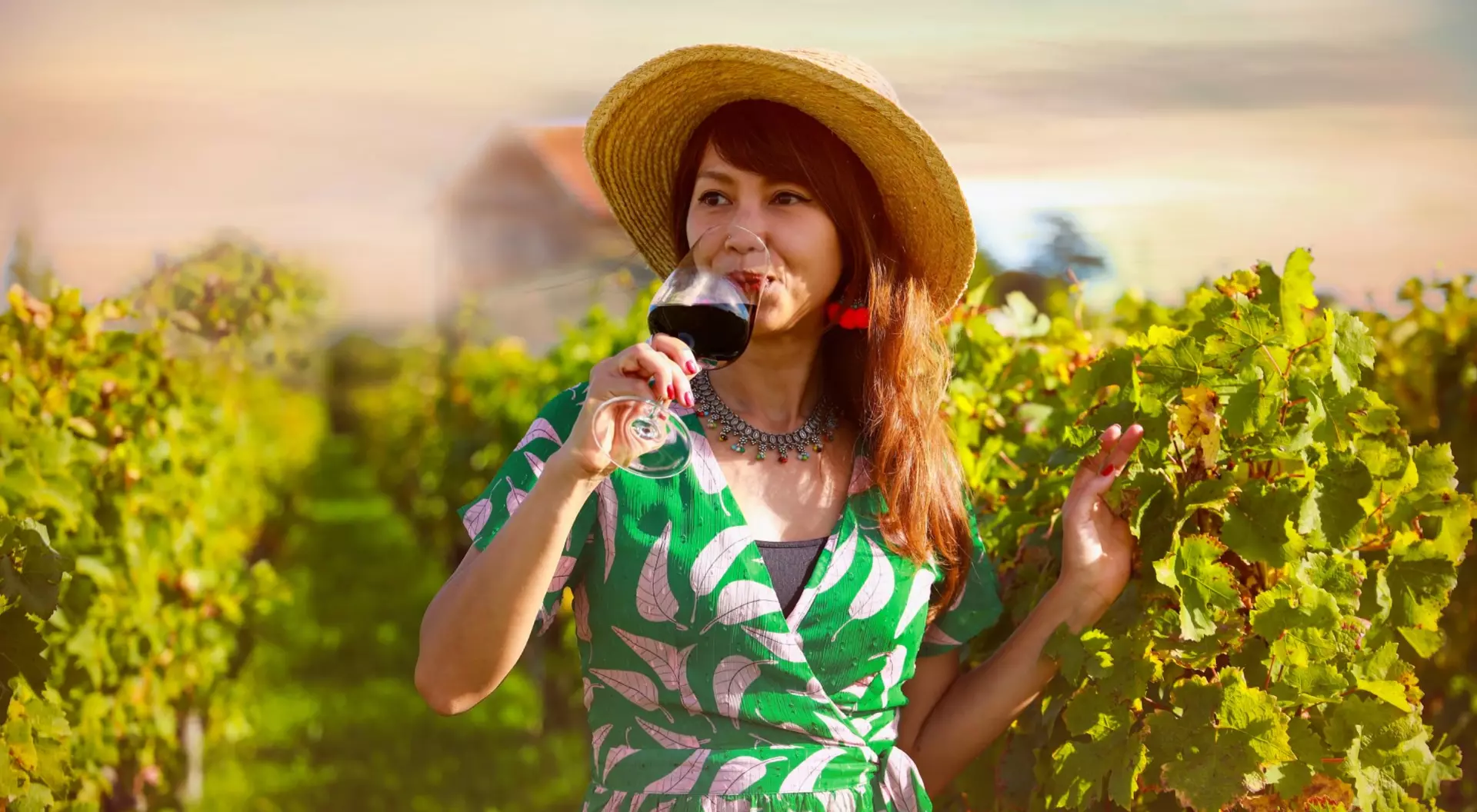 woman in vineyard drinking some wine