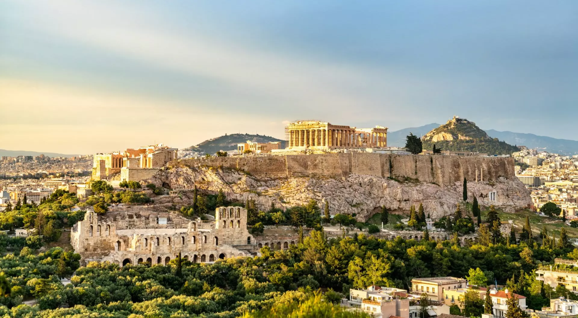 ancient ruins on a hill overtop a city