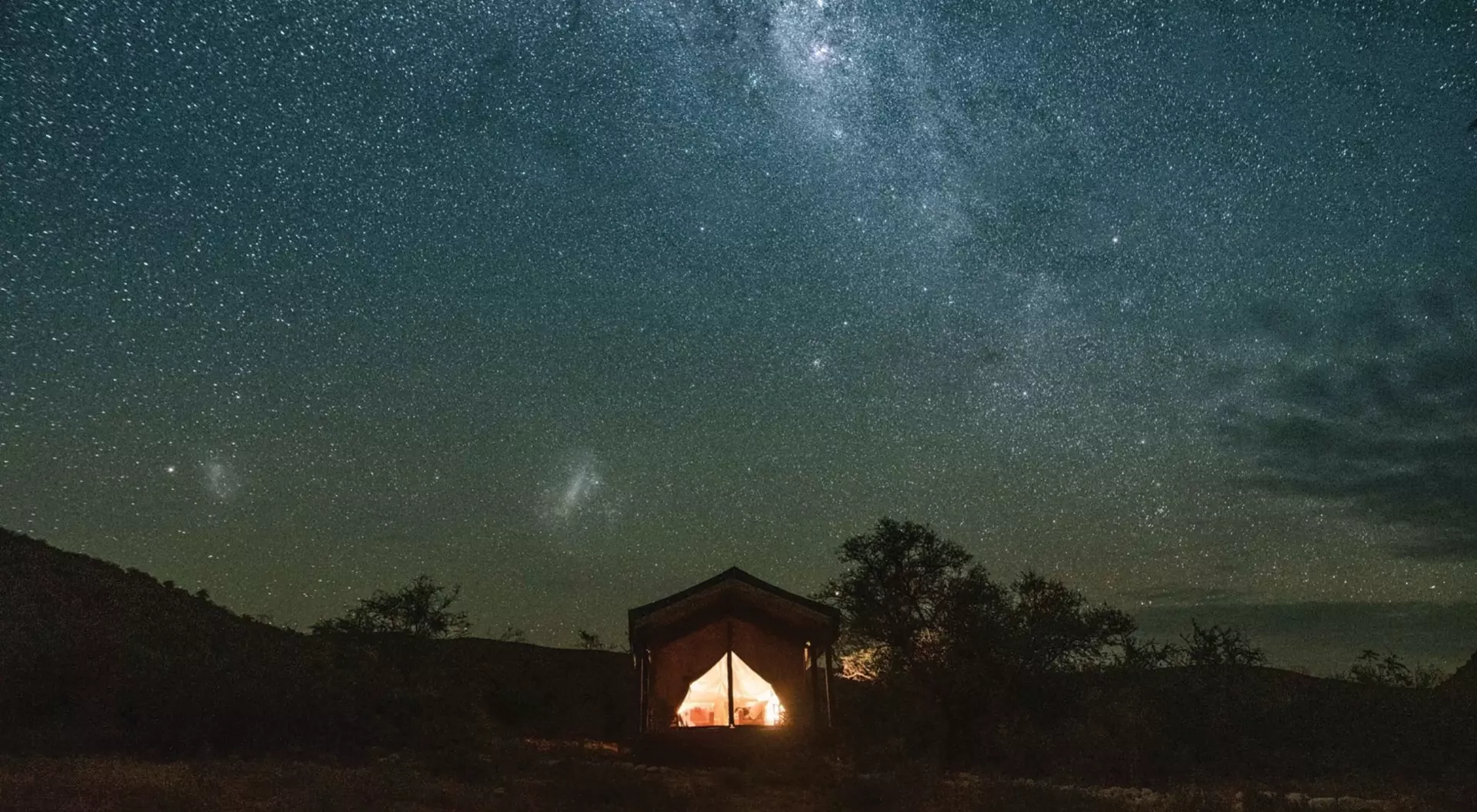 Western Cape, South Africa (©Wesgro) The brilliant colours of the Milky Way light up the dark wilderness of a tent on the Western Cape.