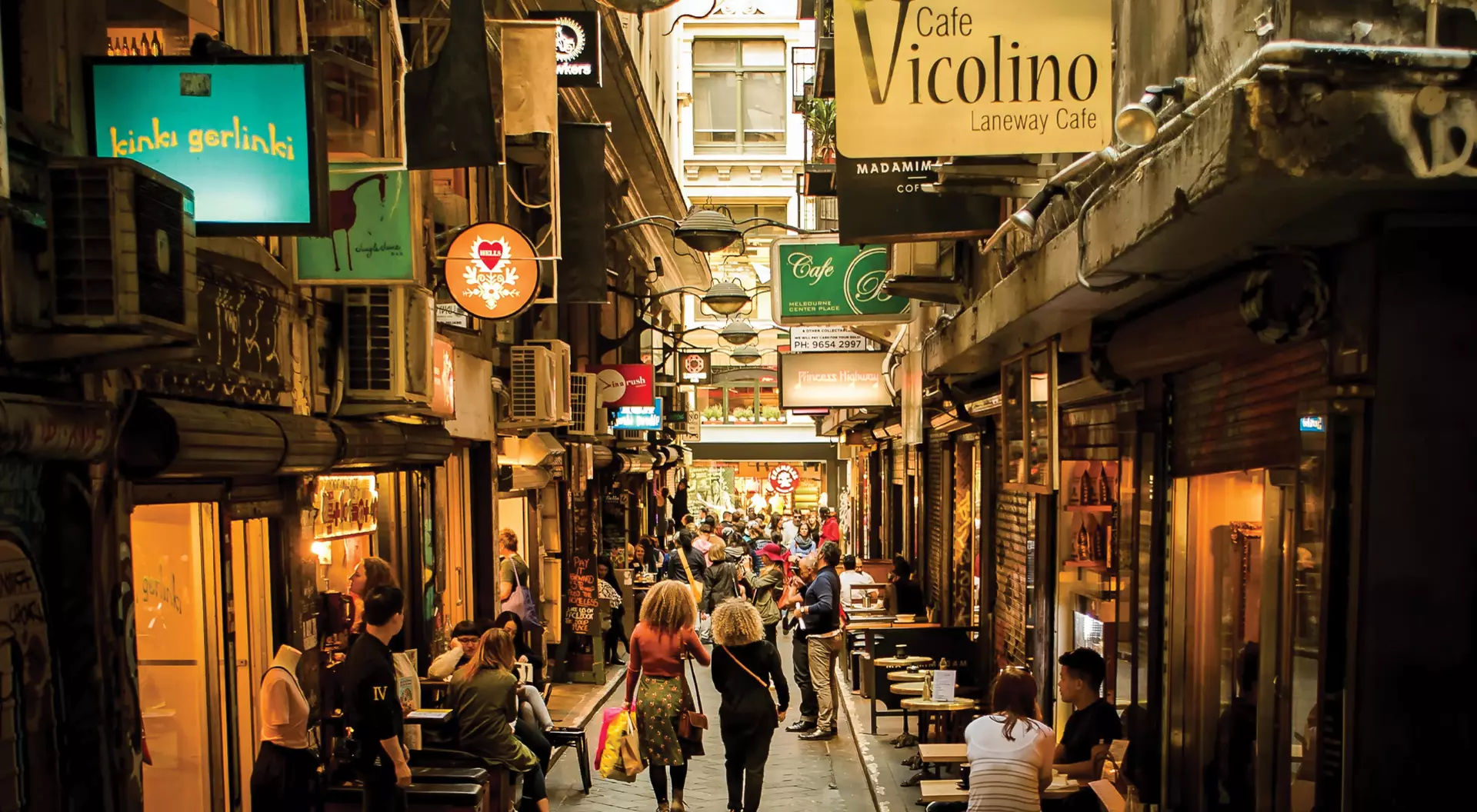 Melbourne, Australia people walking down a laneway with restaurants
