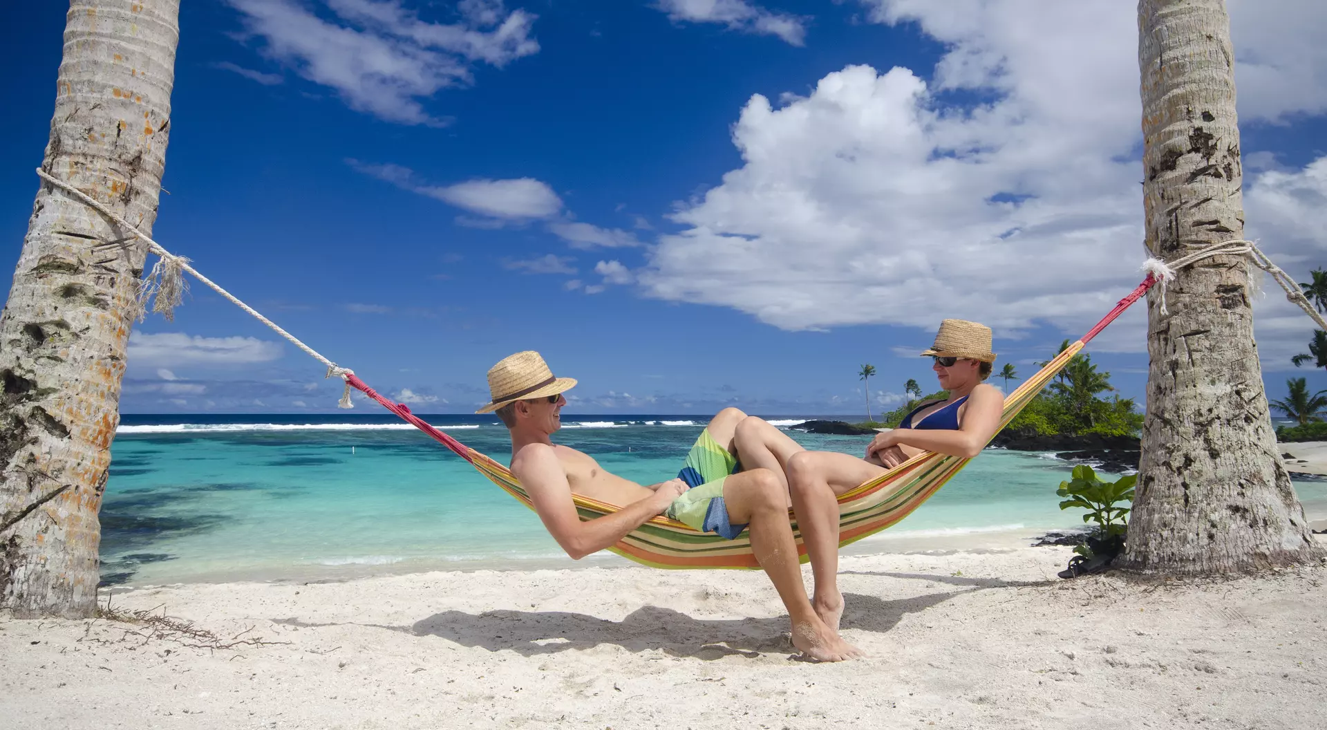 Samoa Couple relaxing in hammock on a beach
