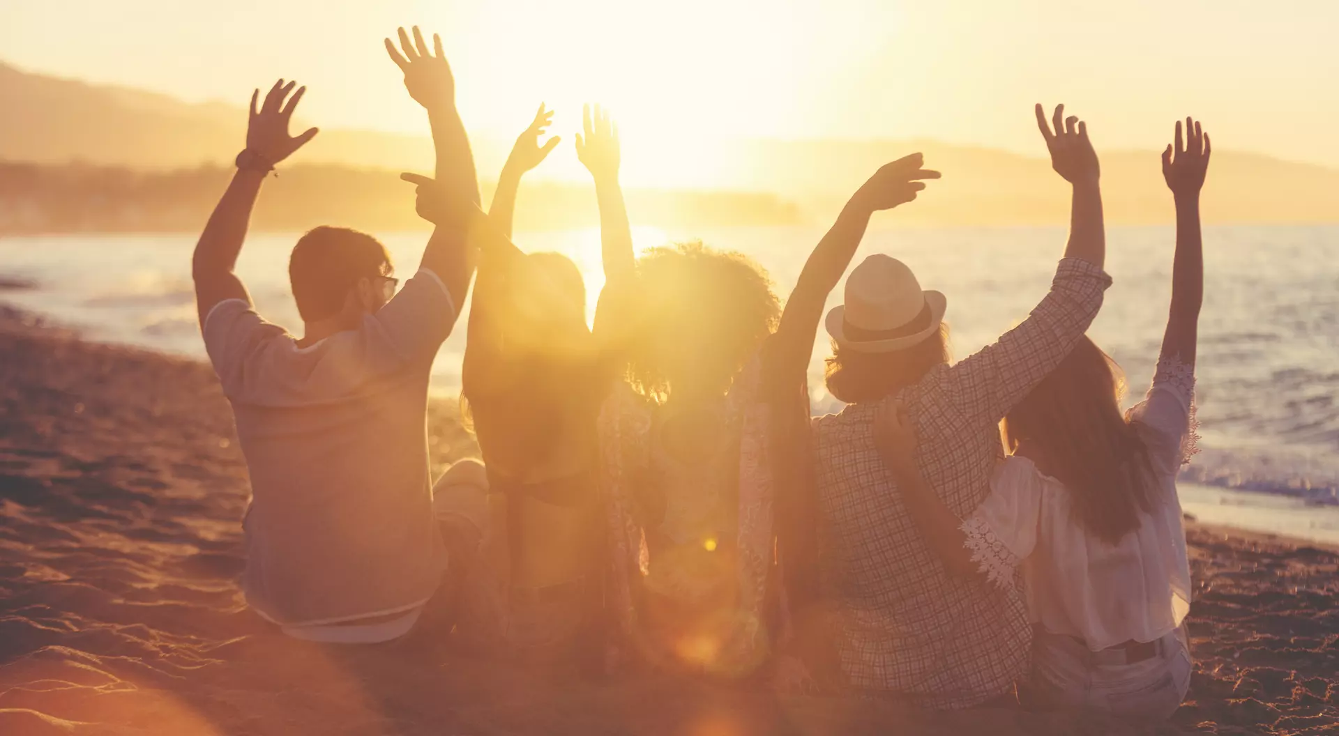 Group of friends sitting on the beach