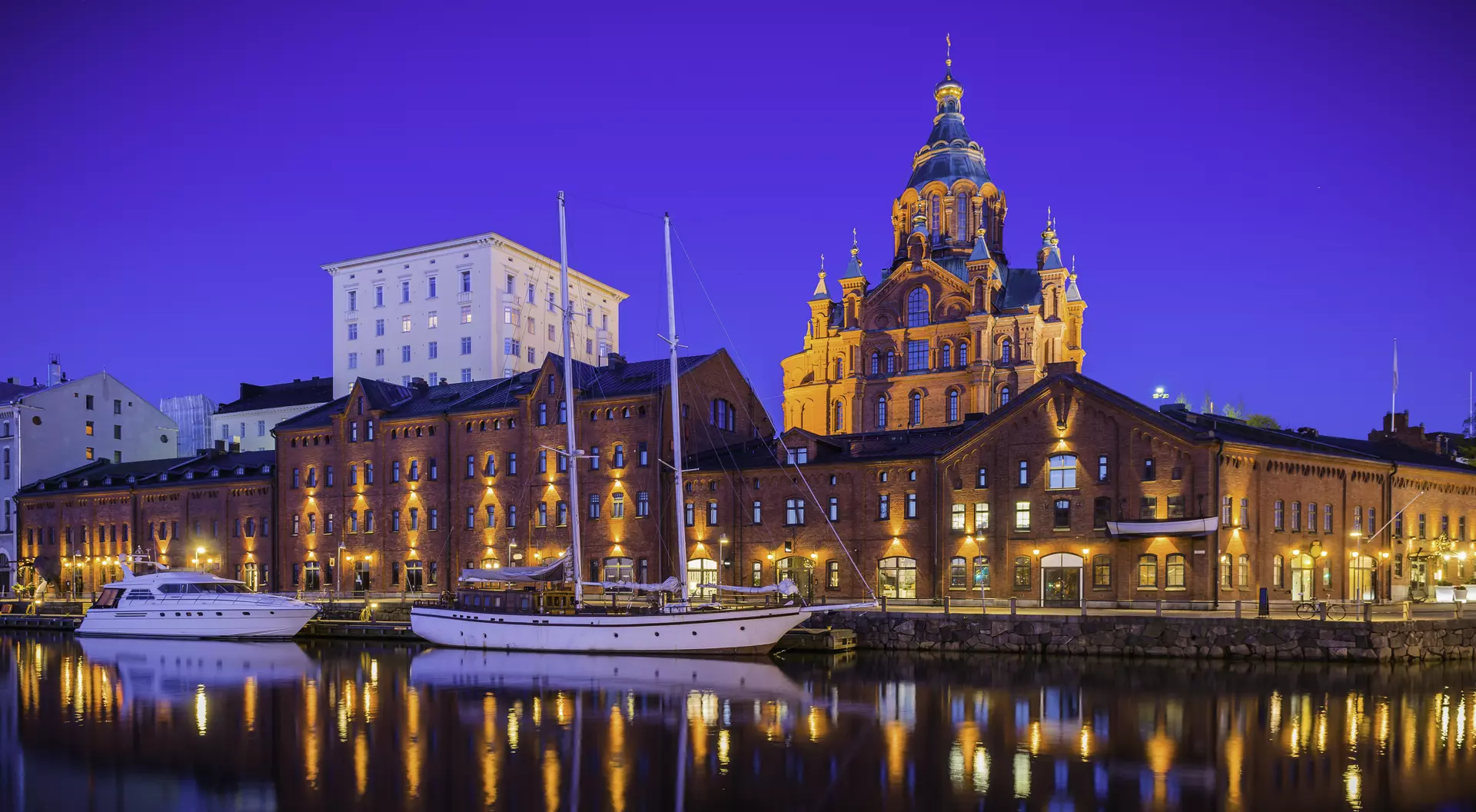 Helsinki, Finland Helsinki Uspenski Cathedral reflecting in illuminated marina tranquil waterfront Finland