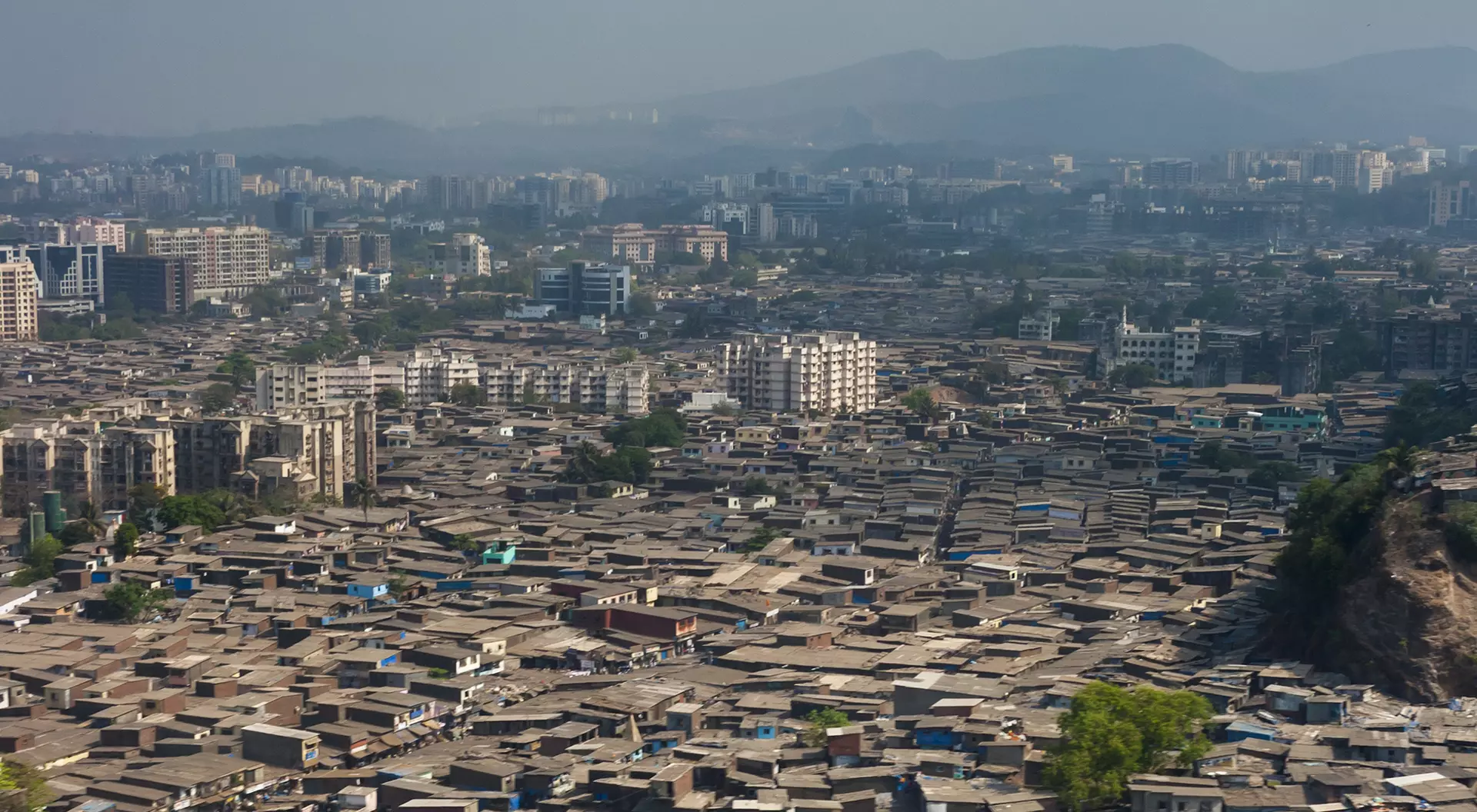 Mumbai, Dubai The slums of Mumbai, seen from the air, fill every gap between larger residential buildings and offices