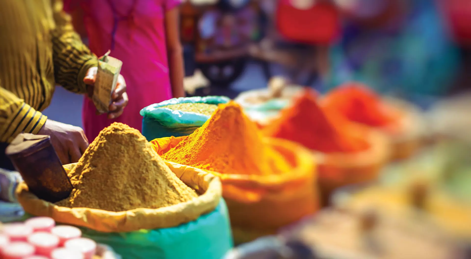 Colorful spices powders and herbs in traditional street market in Delhi. India