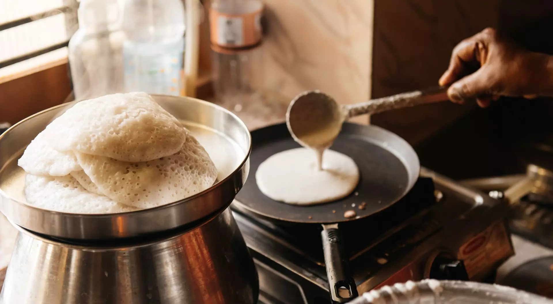 man cooking pancake on traditional stovetop