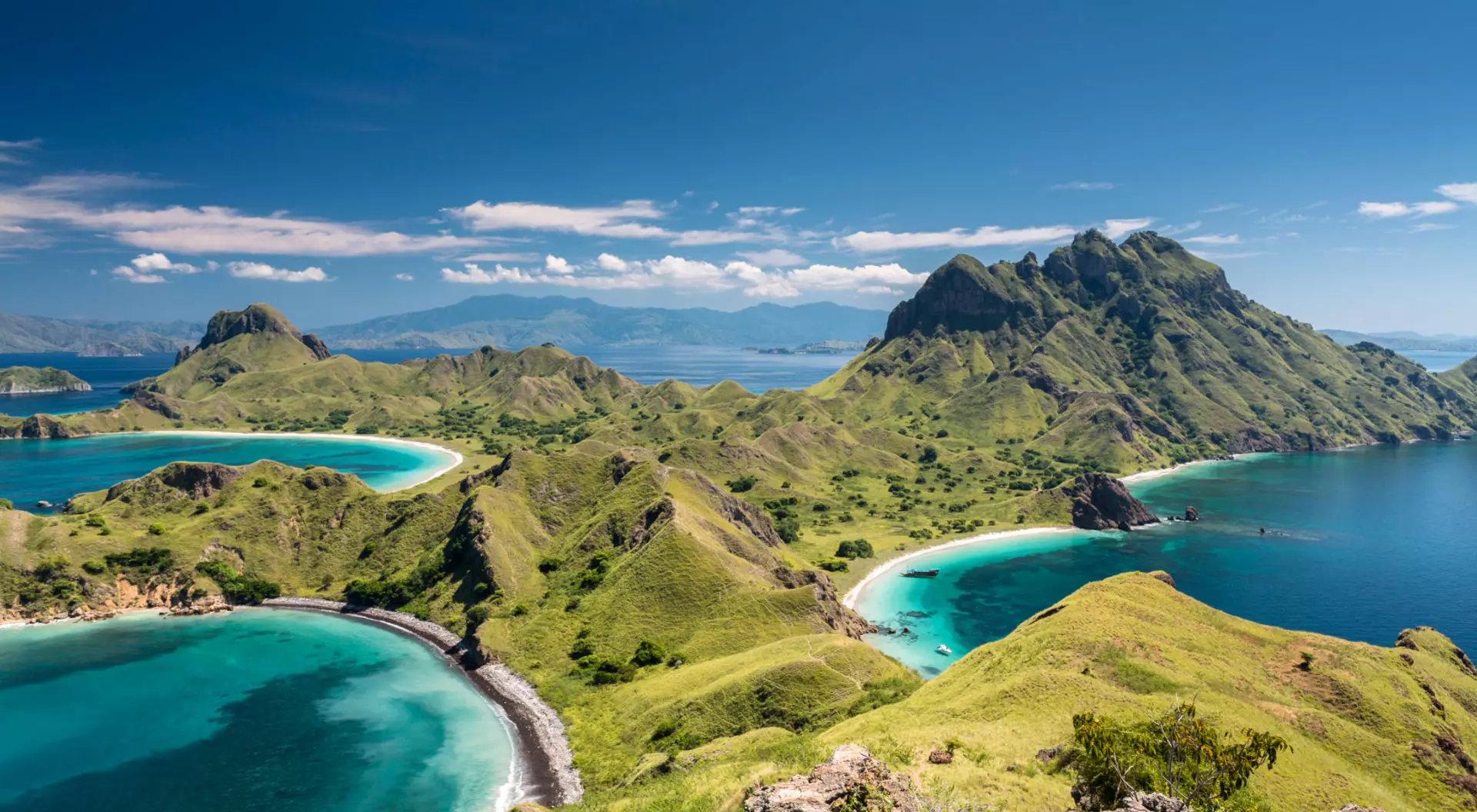 Aerial view of green land and blue ocean on Komodo Island in Indonesia.