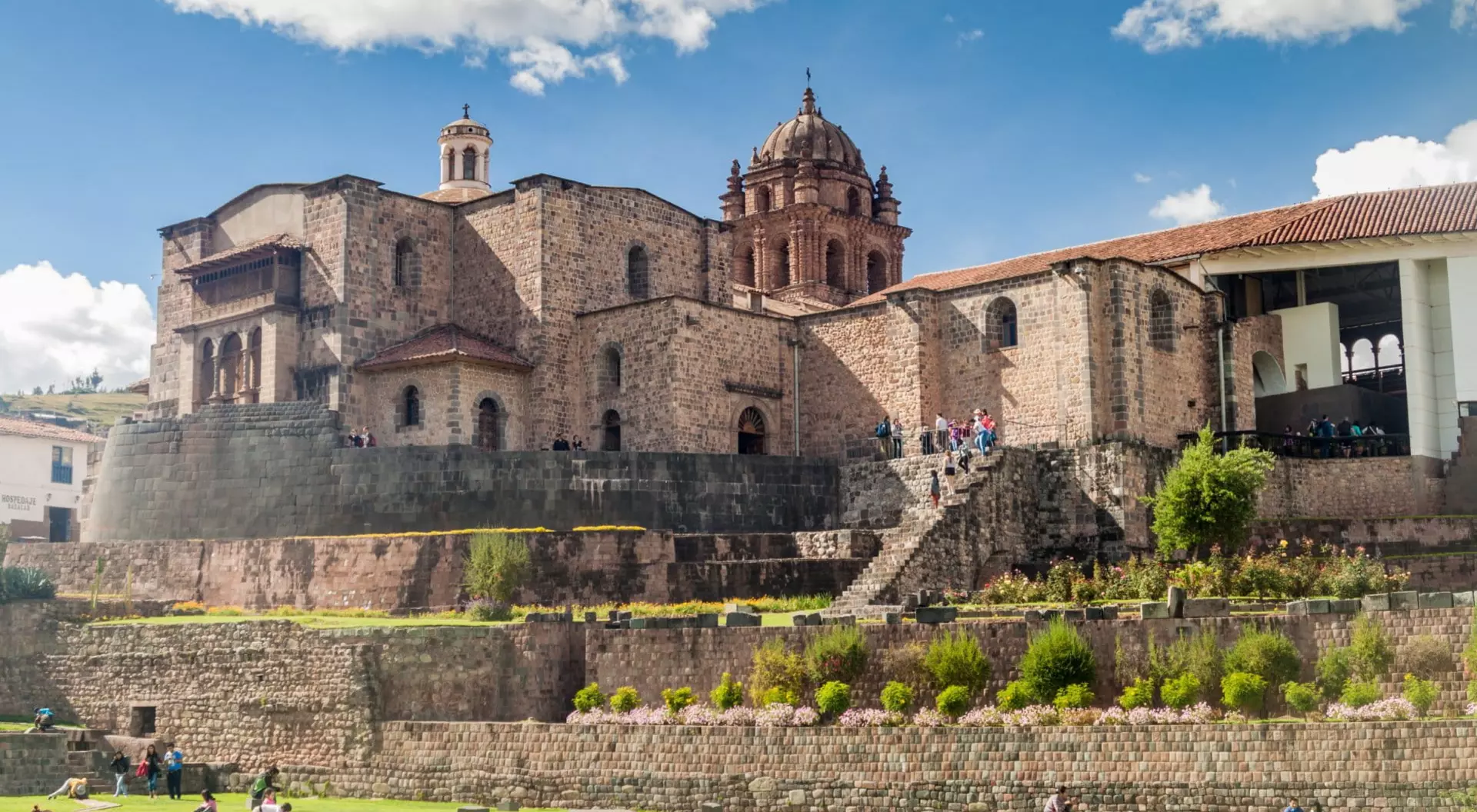church built on top of ruins in front of walls and garden