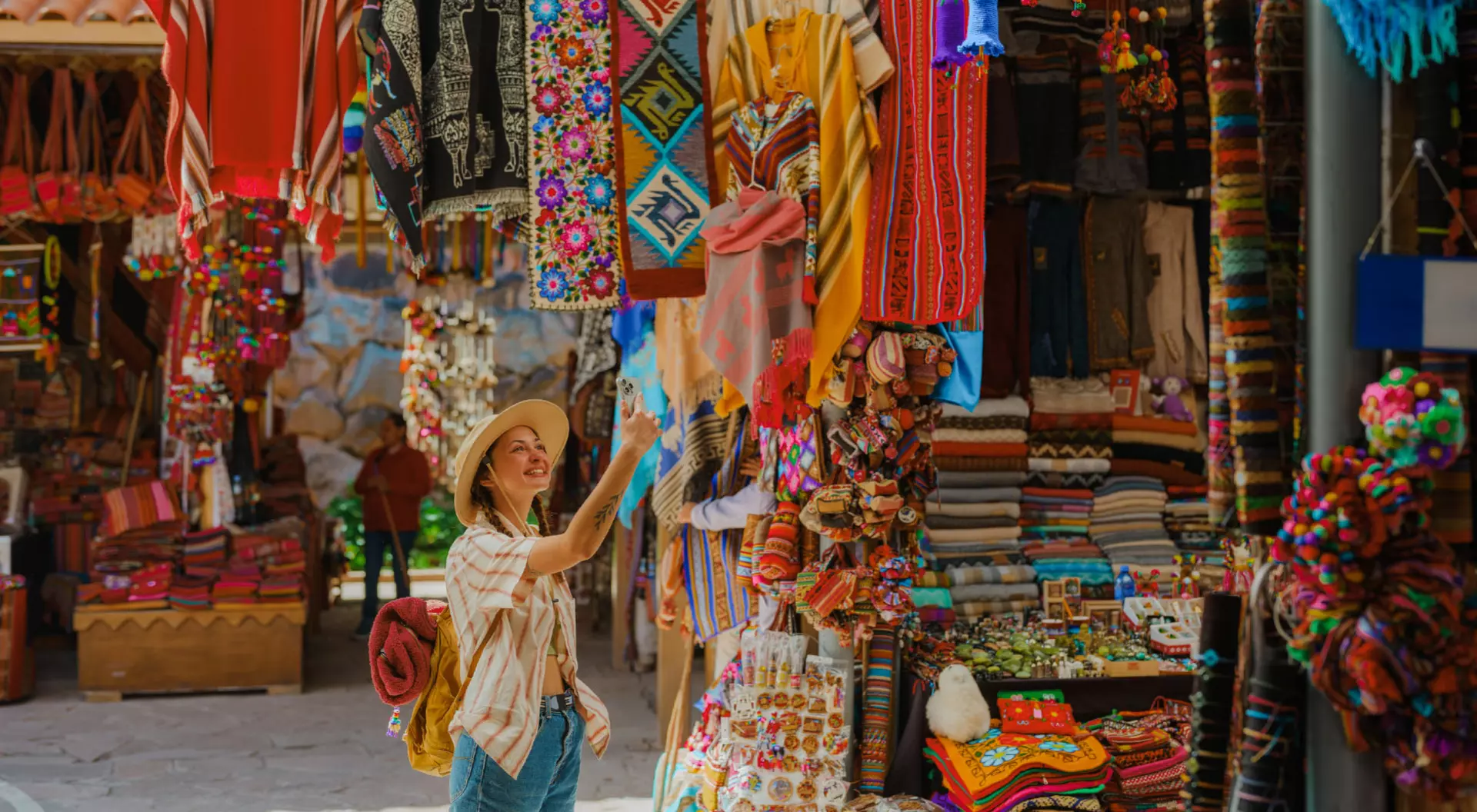 A woman walks through a Quechua market in Pisac, Peru