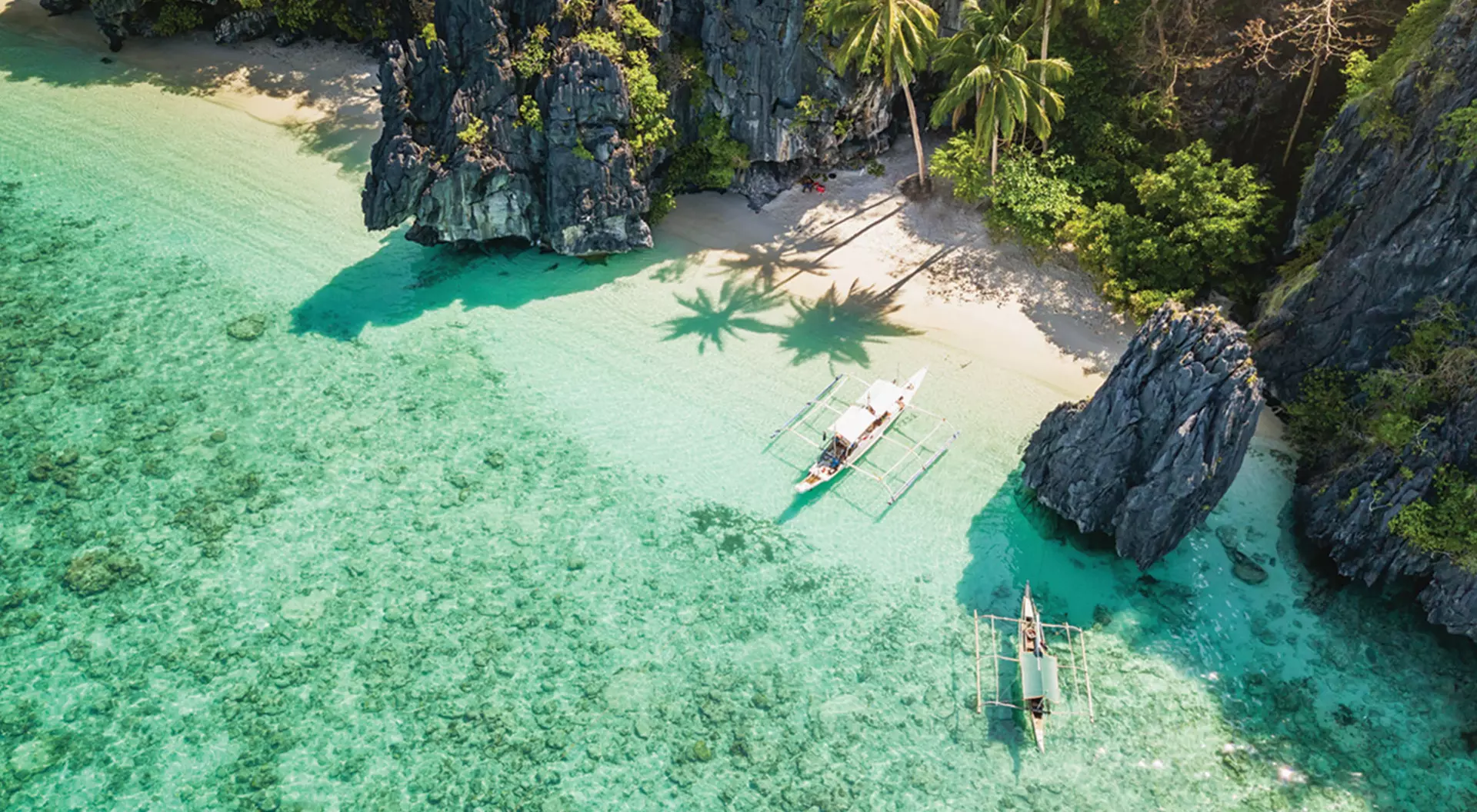 An aerial view of boats in the water of El Nido, Palawan in the Philippines