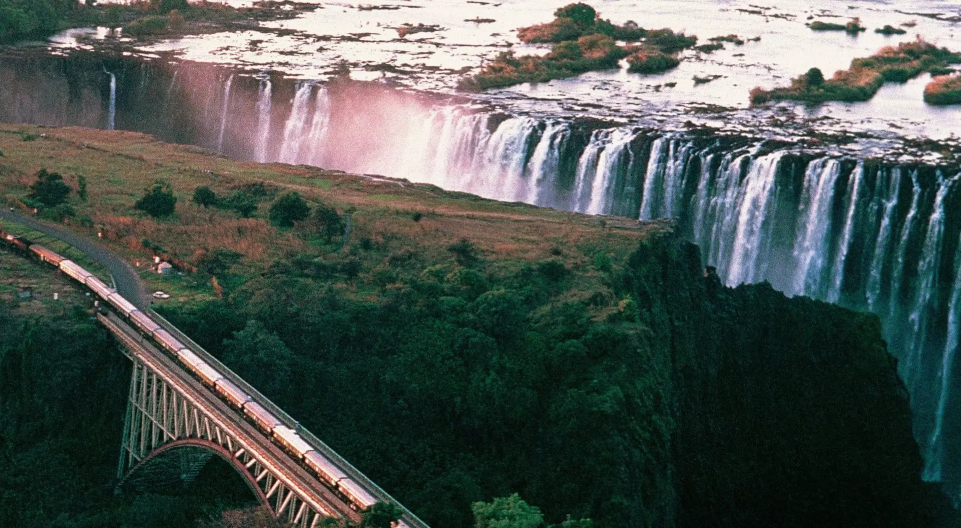 Rovos Rail, Victoria Falls (©Rovos Rail) Aerial view of the Rovos Rail train heading alongside Victoria Falls in Zimbabwe