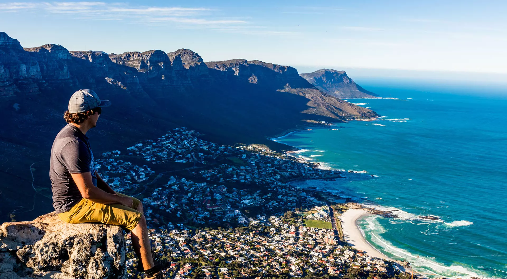 Cape Town, South Africa A man overlooking Cape Town from a ledge on Table Mountain