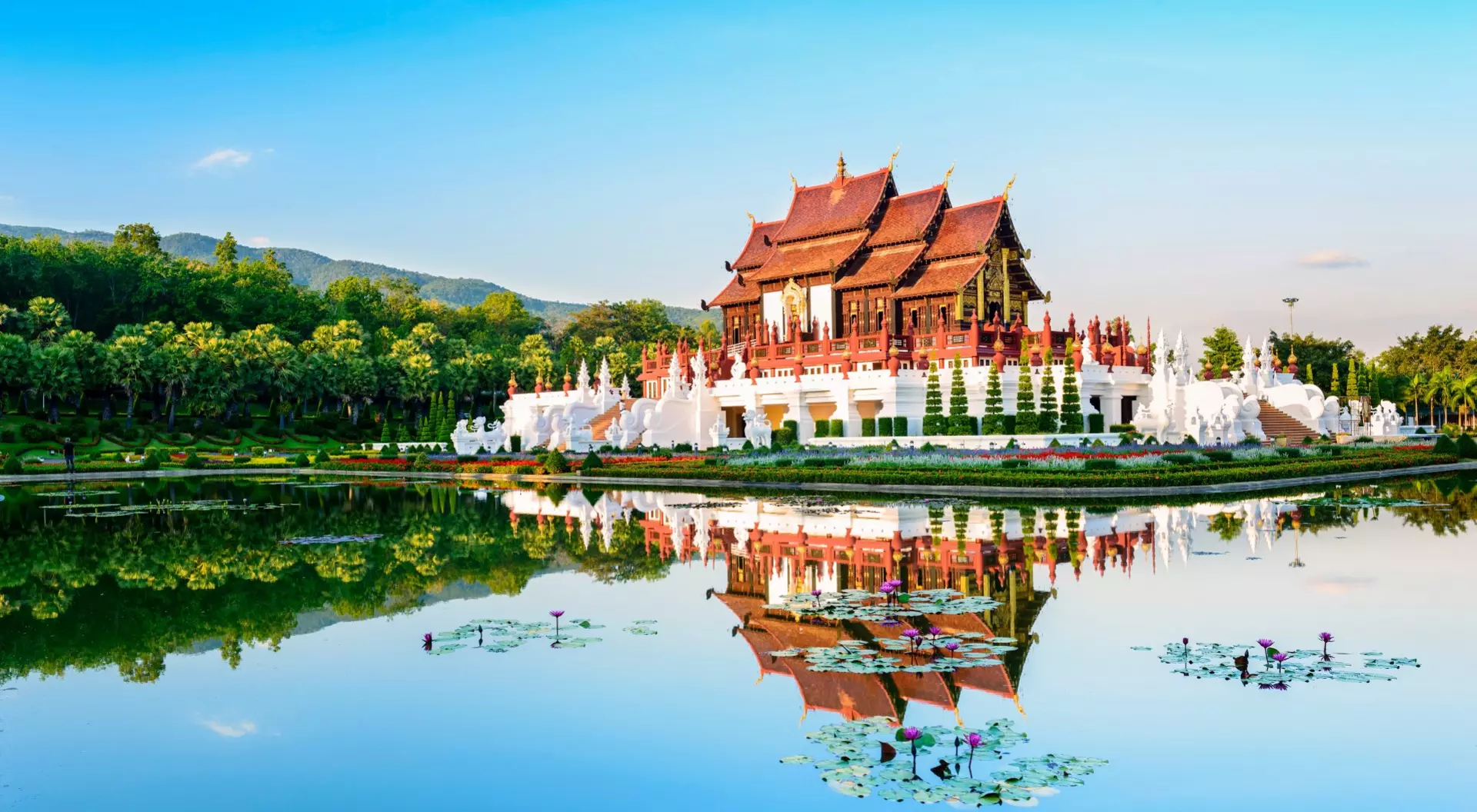 A temple in Chiang Mai, Thailand creates a perfect reflection in the surrounding pond.