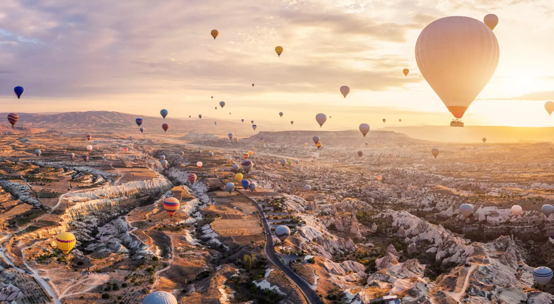 Cappadocia, Türkiye Hot air balloons rise over the fairy tale chimneys of Turkiye's Cappadocia against sunrise