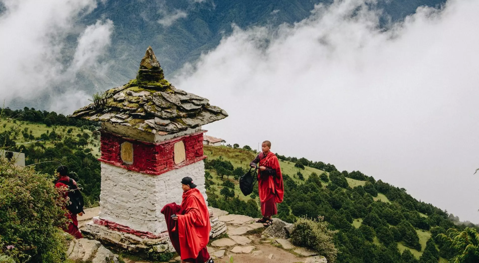monks on red and white temple