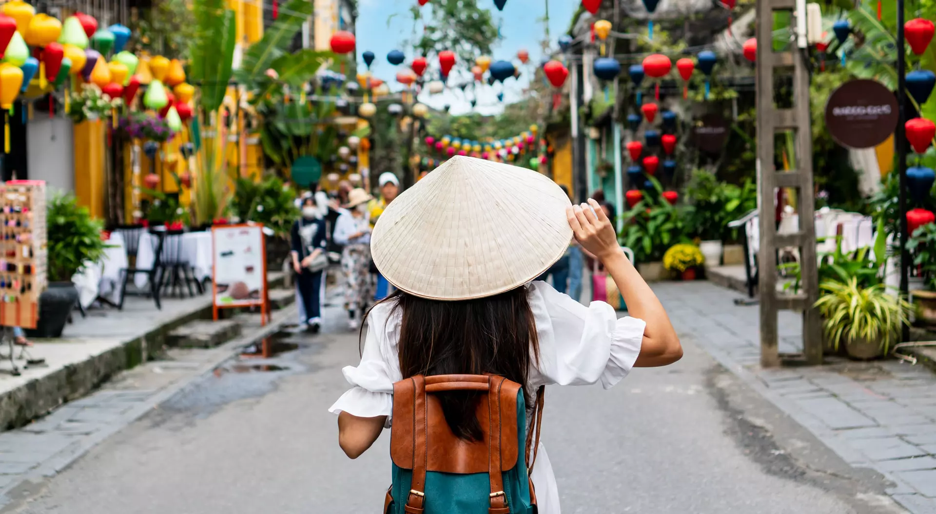 Hanoi, Vietnam A woman wearing a traditional ricepicking hat walks through the streets of Hanoi in Vietnam